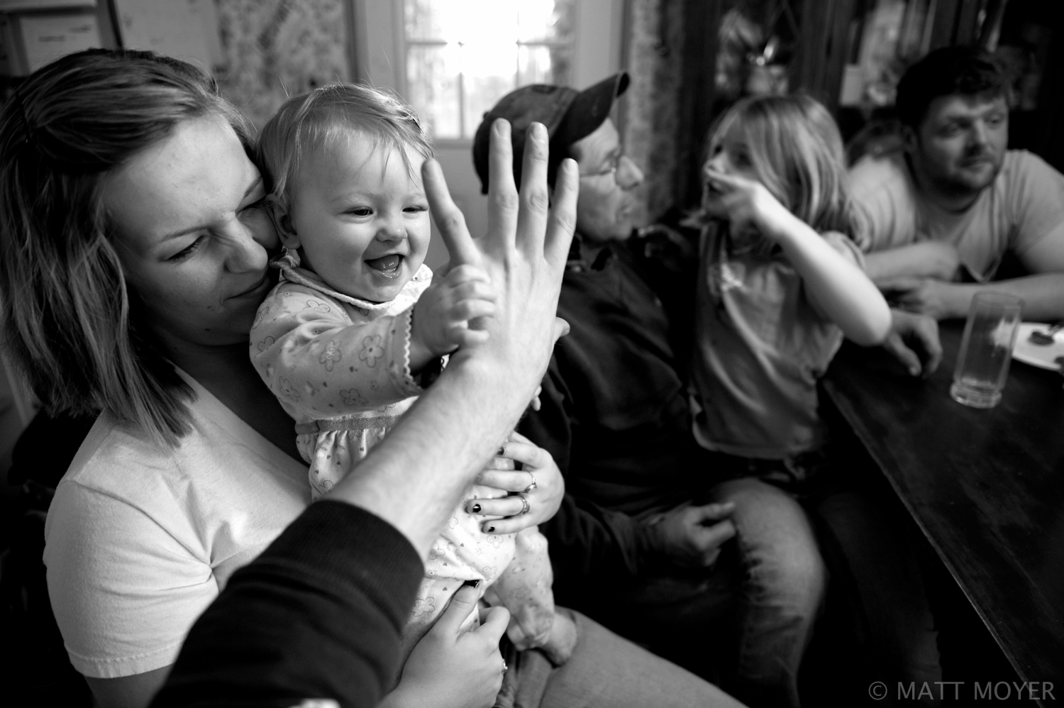  Jessica Tidd holds her niece, Leah, as Joe Tidd, Jessica's father, holds his granddaughter, Emma, during a Sunday family dinner in Auburn, NY. 