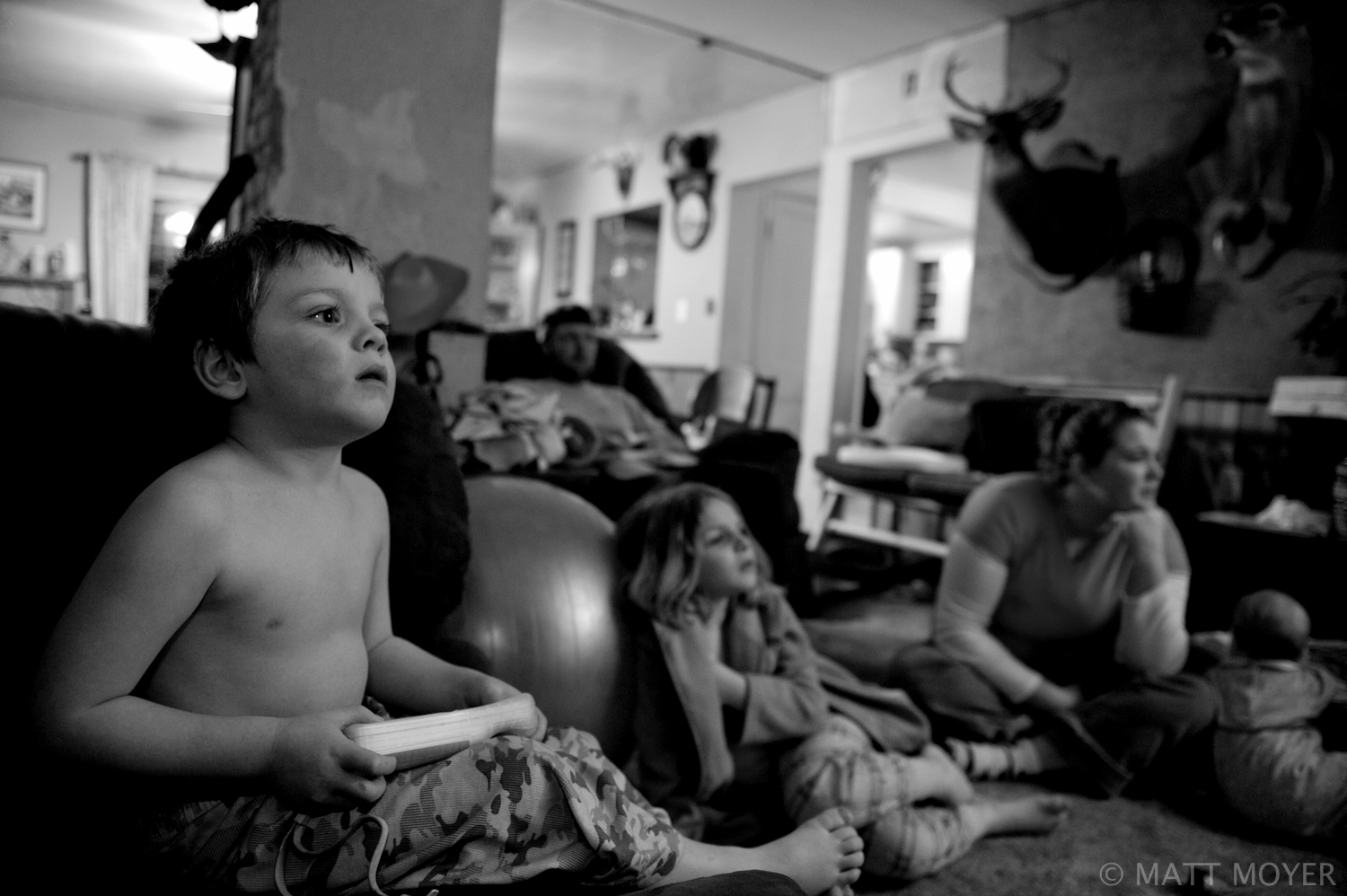  J Tidd, 4, plays video games as his father, Ed Tidd, a dairy farmer in up state New York, sits in the background. Ed Tidd is in business with his father Joe Tidd running the small dairy operation. 