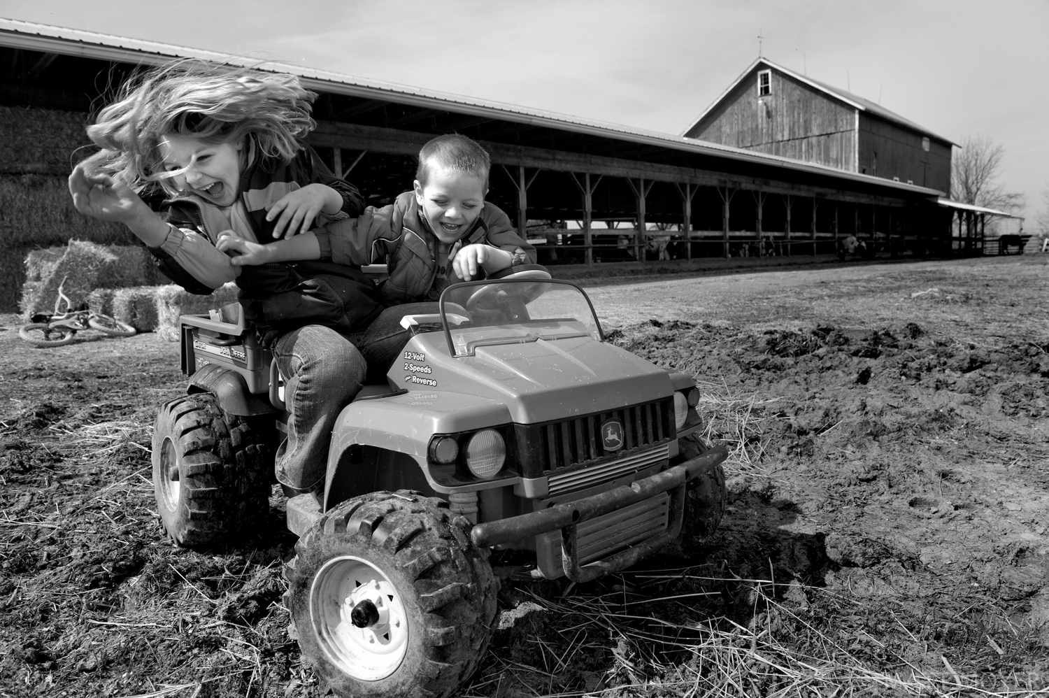  AJ Tidd, 4, right, and his sister Emma, 6, play on their family farm in Auburn, NY. 