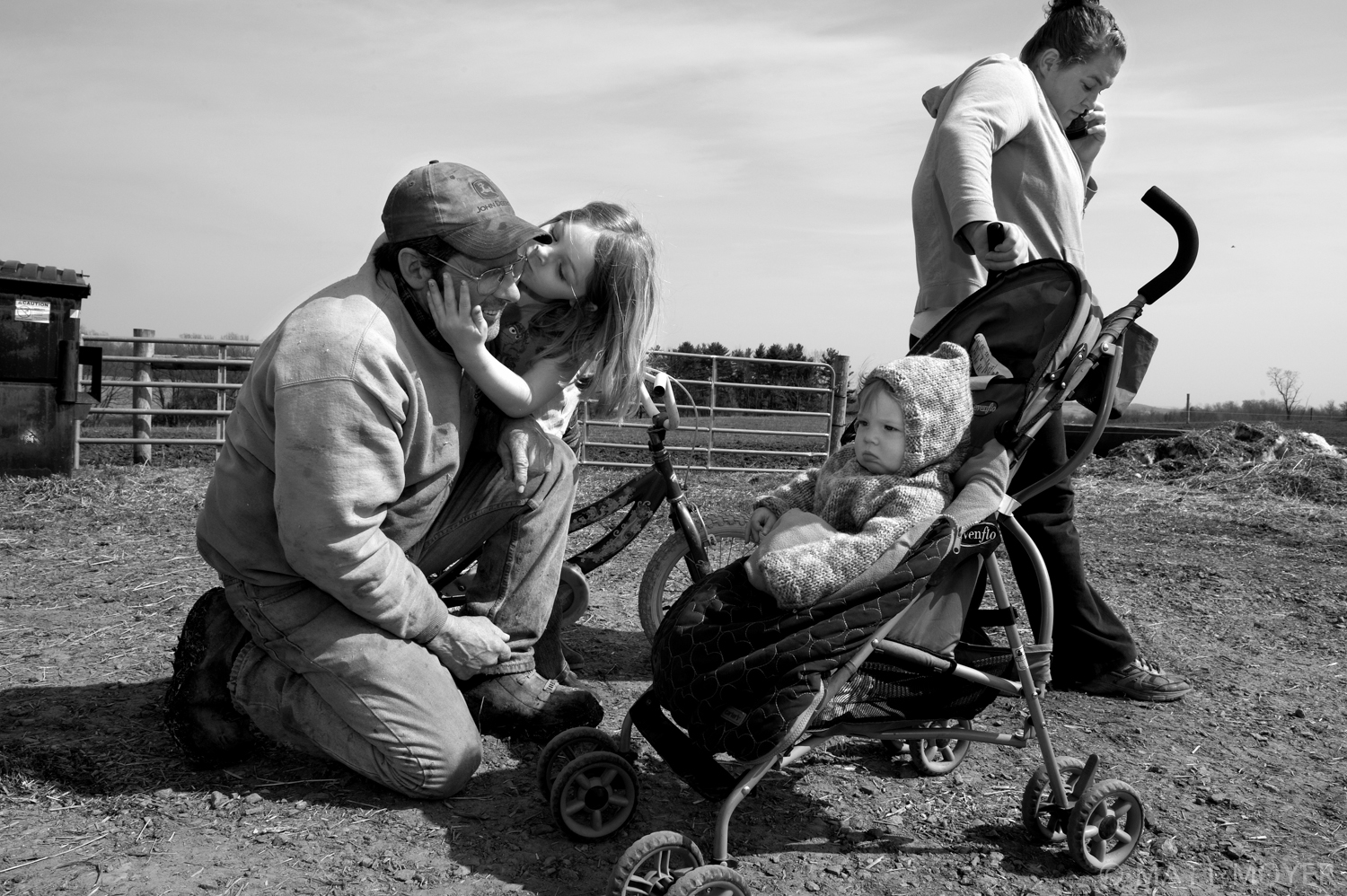  Joe Tidd takes a break from working on the family farm to say hi to his grandchildren Emma, 6, and Leah, 8 months, in Auburn, NY. 