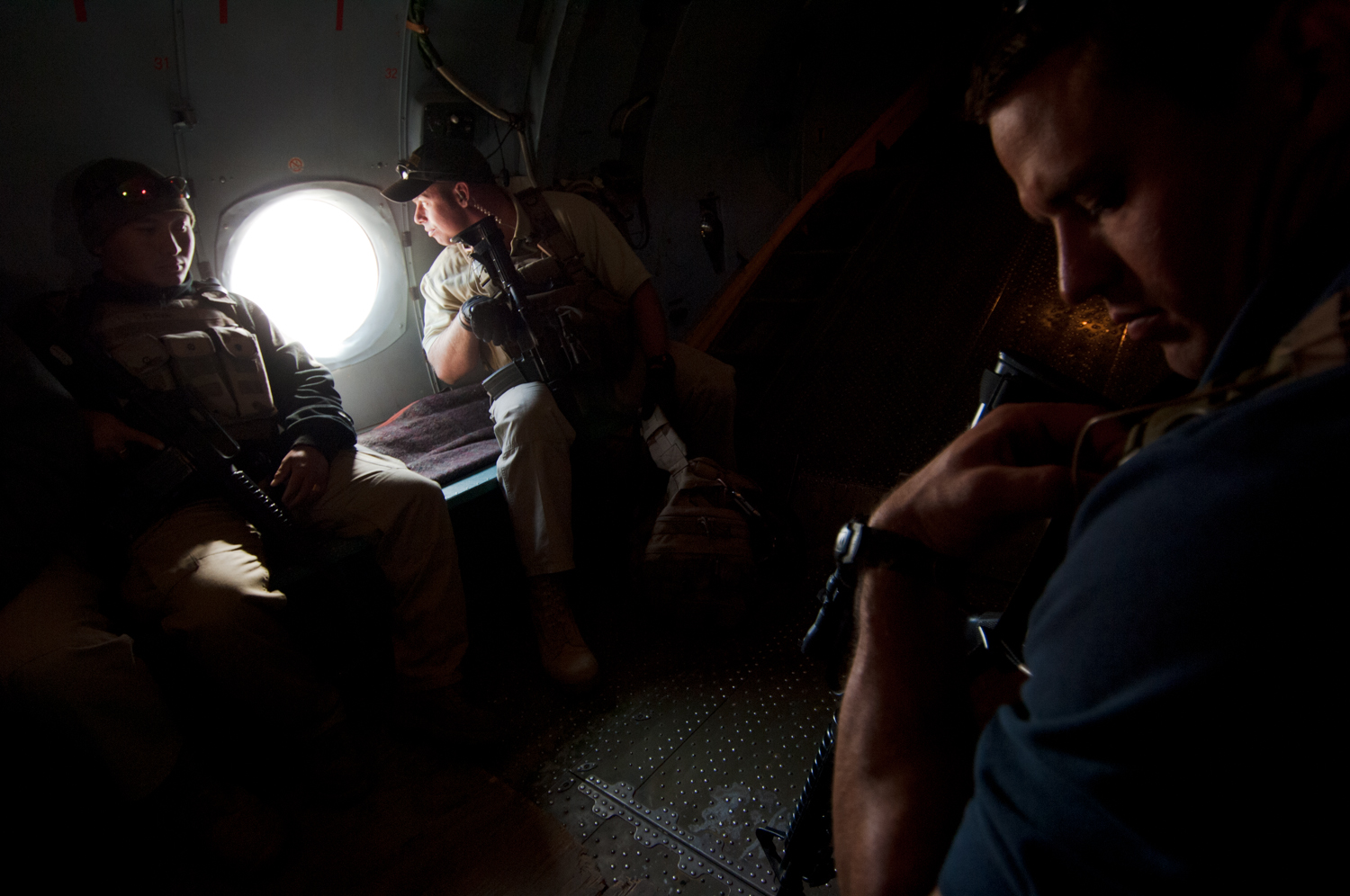  Members of a personal security detail ride in the belly of a Soviet era cargo plane while providing protection for U.S. State Department officials over Kabul, Afghanistan. 