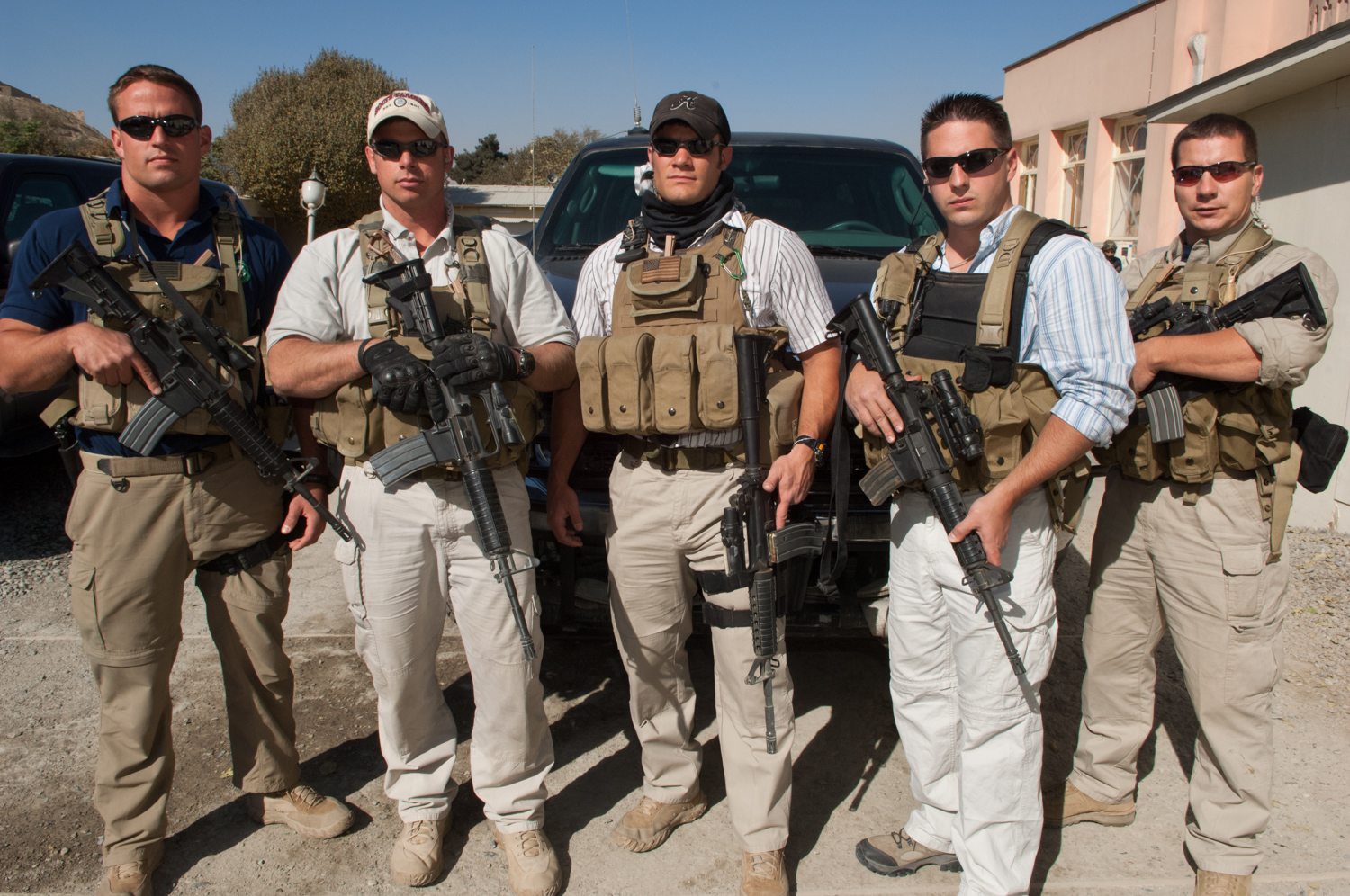  Private security contractors (L to R) Pat Scott, Mike Stocksett, 32, Neil Gary, 26, Matt Goss, 24, and Kyle Kaszynski, 39, pose for a photograph while on a break from providing security in Kabul, Afghanistan. These men work for the private military 