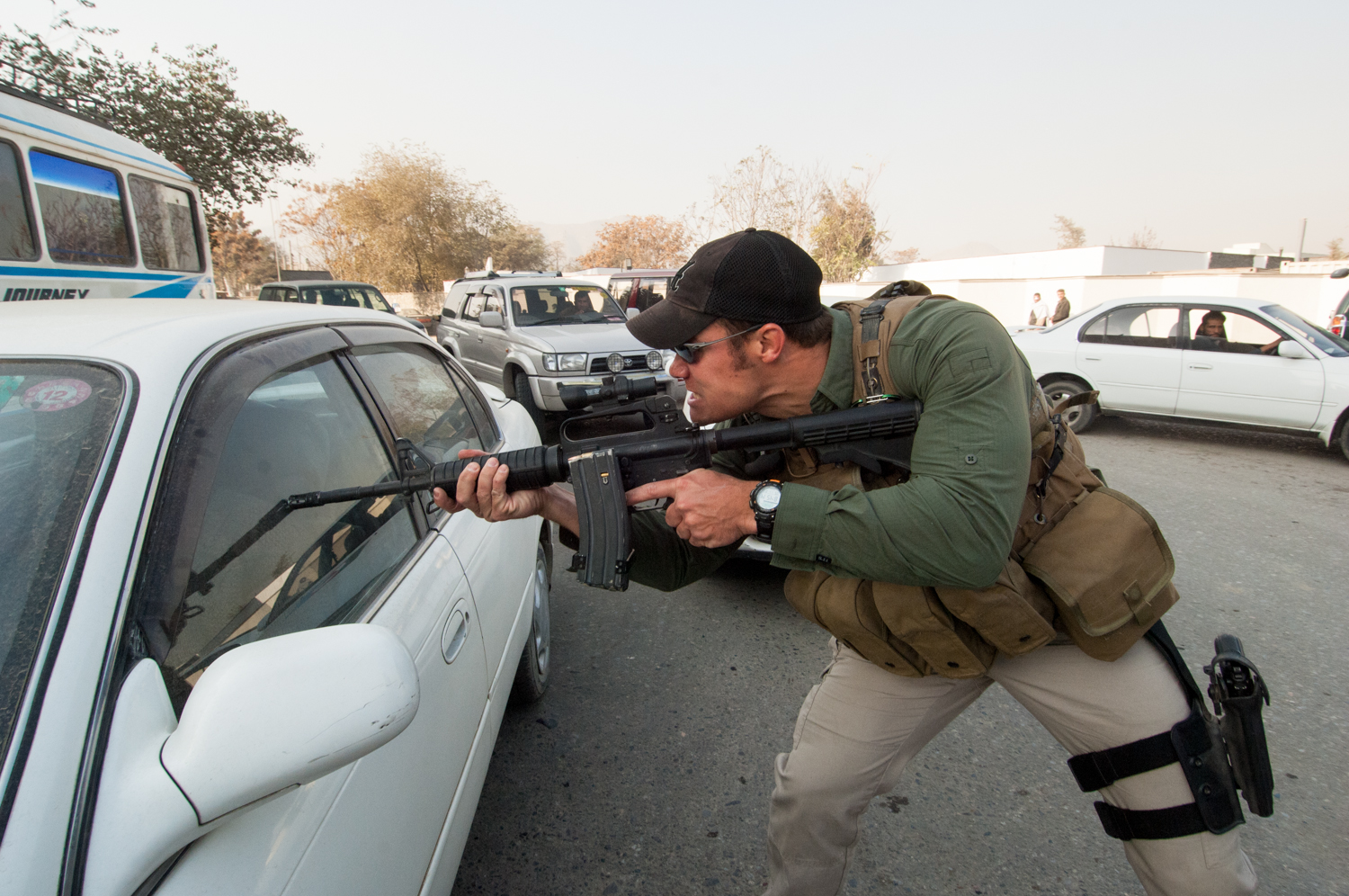  Private security contractor, Neil Gary, a former U.S. Marine, orders a driver at gunpoint to move his car while working to provide security for a convoy in Kabul, Afghanistan. 