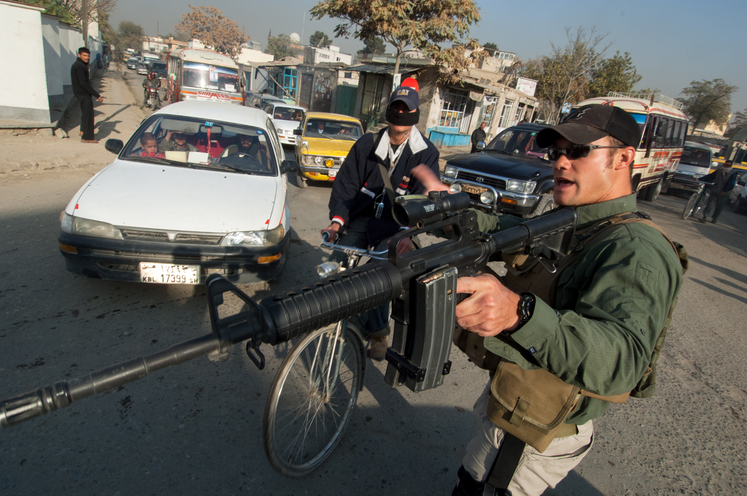 Private security contractor, Neil Gary, 26, a former U.S. Marine, points his weapon while providing security for a convoy in Kabul, Afghanistan. 