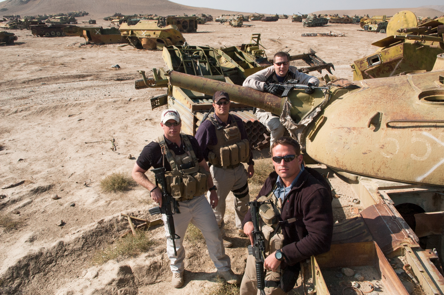  Private security contractors (L to R) Mike Stocksett, 32, Neil Gary, 26, Kyle Kaszynski, 39, and Pat Scott (Front) pose for a photograph in a tank graveyard in Kabul, Afghanistan. The men who decide to work as private security contractors often base