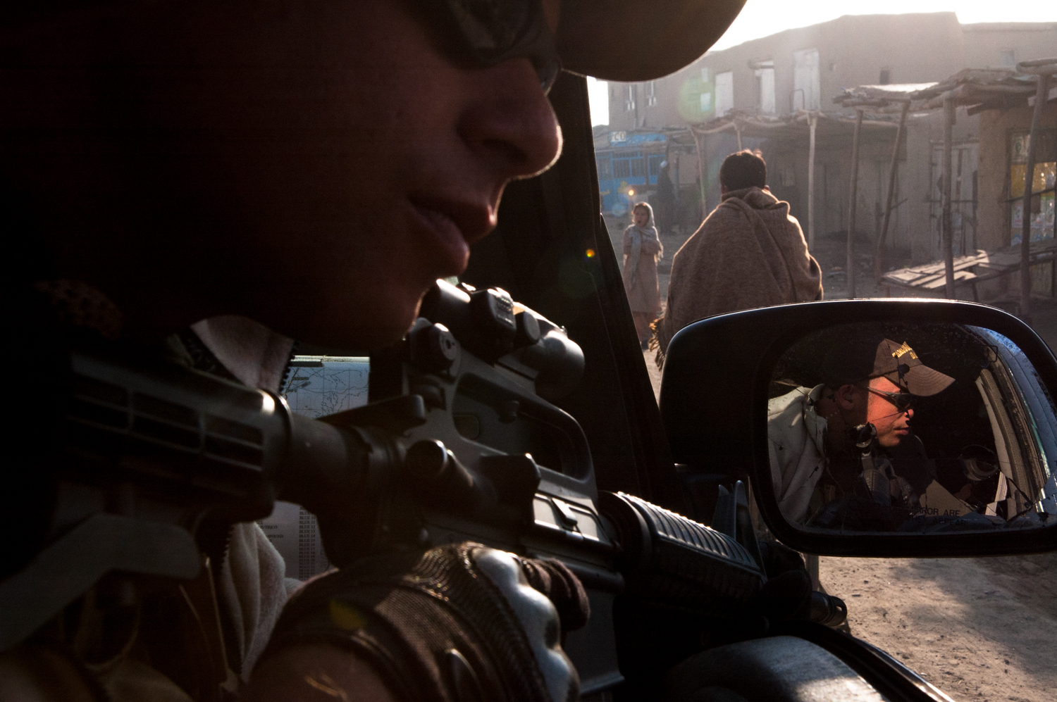  Private security contractor, Mike Stocksett, keeps a sharp eye open for potential threats while providing security for a convoy in Kabul, Afghanistan. Stocksett works for the private military company Crucible providing security for U.S. State Depart