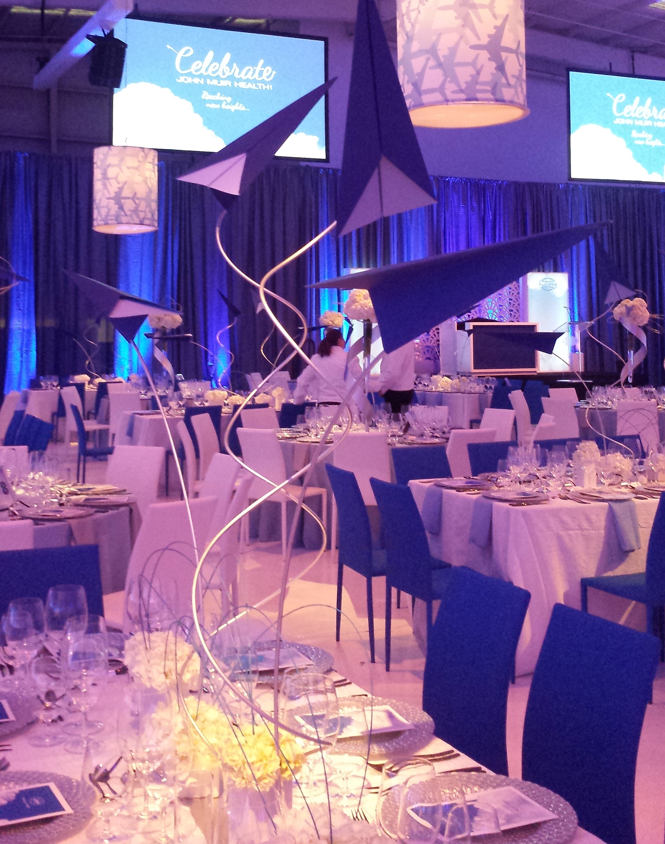 Even though they are see-through in the middle, the paper planes on these center-pieces are obscuring the podium.