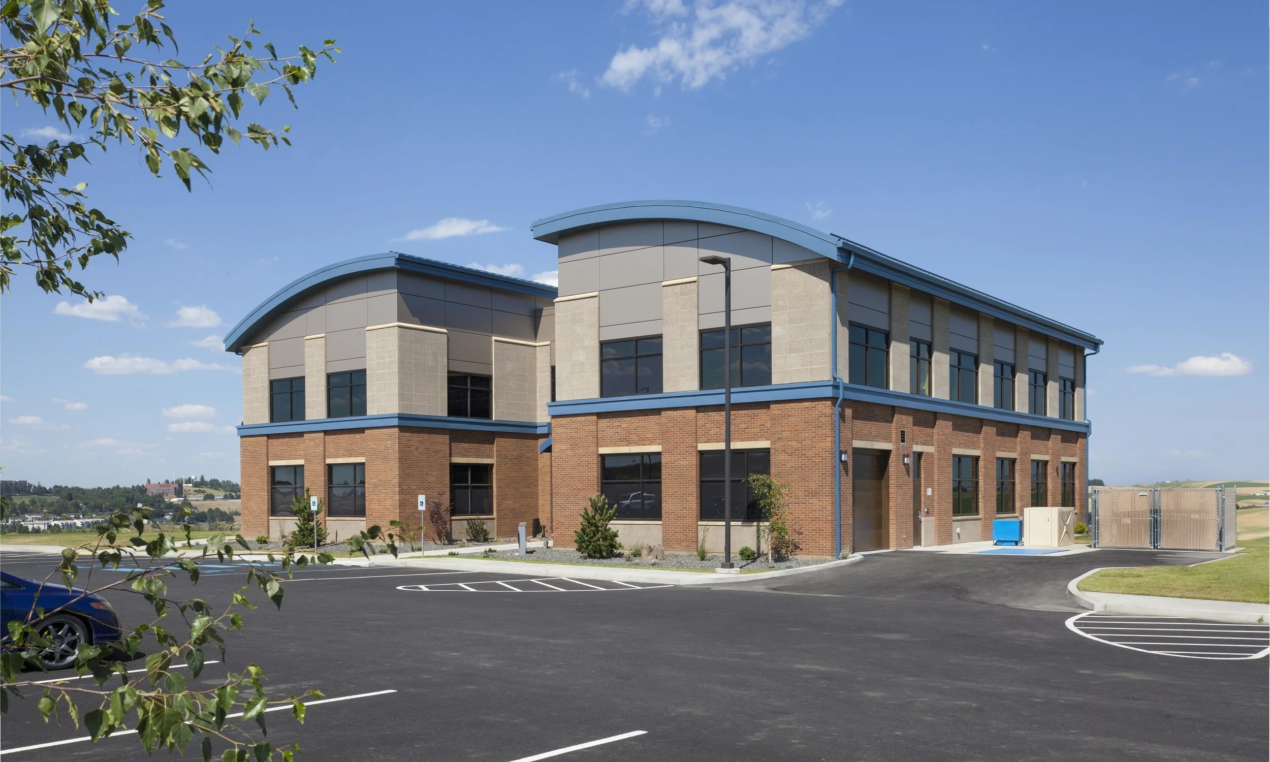 Owner: Relay Application Innovation Location: Pullman, WA The Relay Application Innovation company was the first to build their office in the newly established Palouse Business Center in Pullman, WA. The office building houses the electrical engineering company that is responsible for many of the wind turbines in the nation. Its unique roof line, inspired by the rolling hills of the Palouse, features bow string trusses. The building's U-shaped design and placement on the site were specifically chosen to provide the basis for a three-phased future expansion.