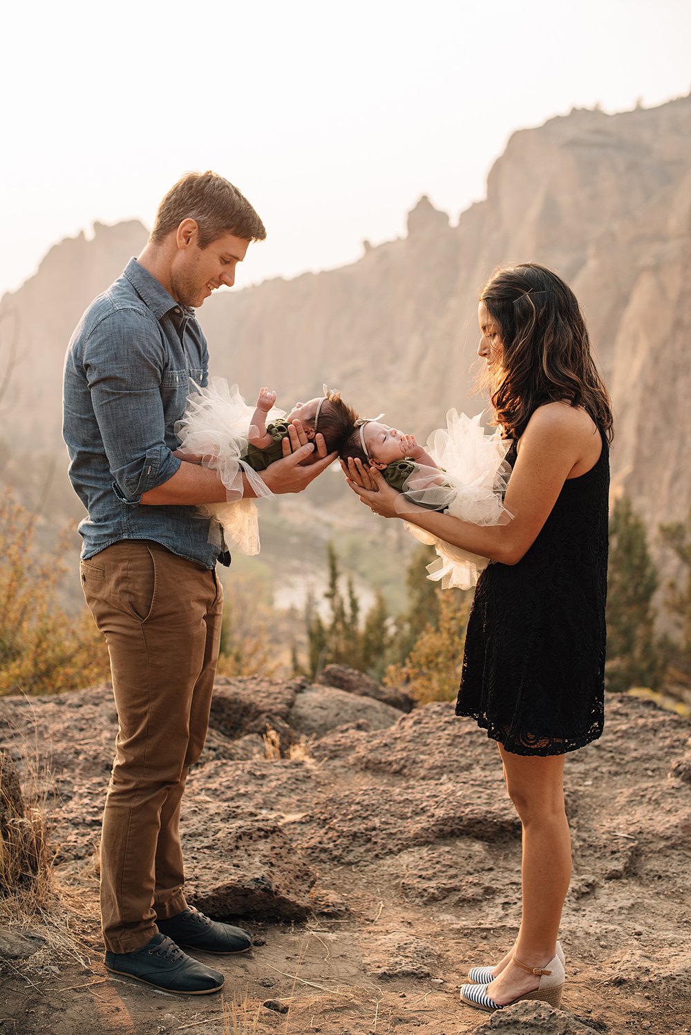  mom and dad hold their newborn girls at smith rock in bend, oregon 