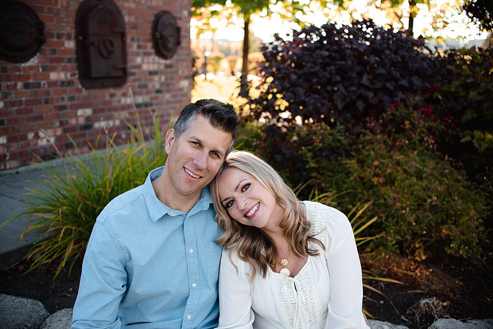  Husband and wife snuggle in together for a photo. 