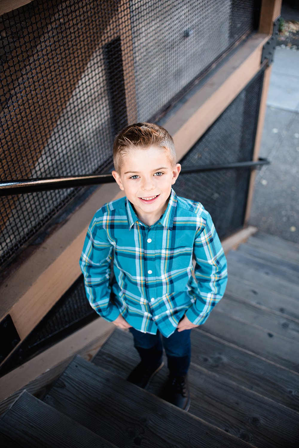  a boy poses on stairs in the Old Mill District&nbsp; 