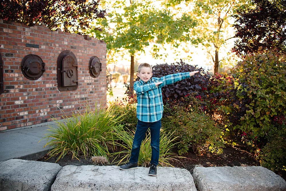 A young boy does the "dab" in the Old Mill District in Bend, Oregon