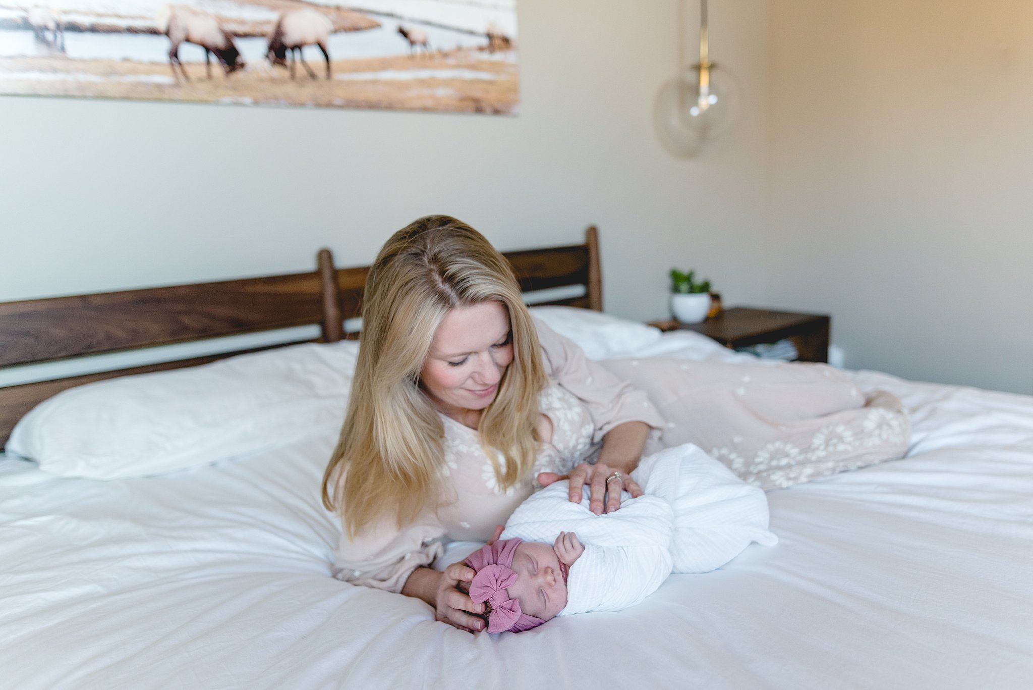  mother and her baby girl lay on the bed 