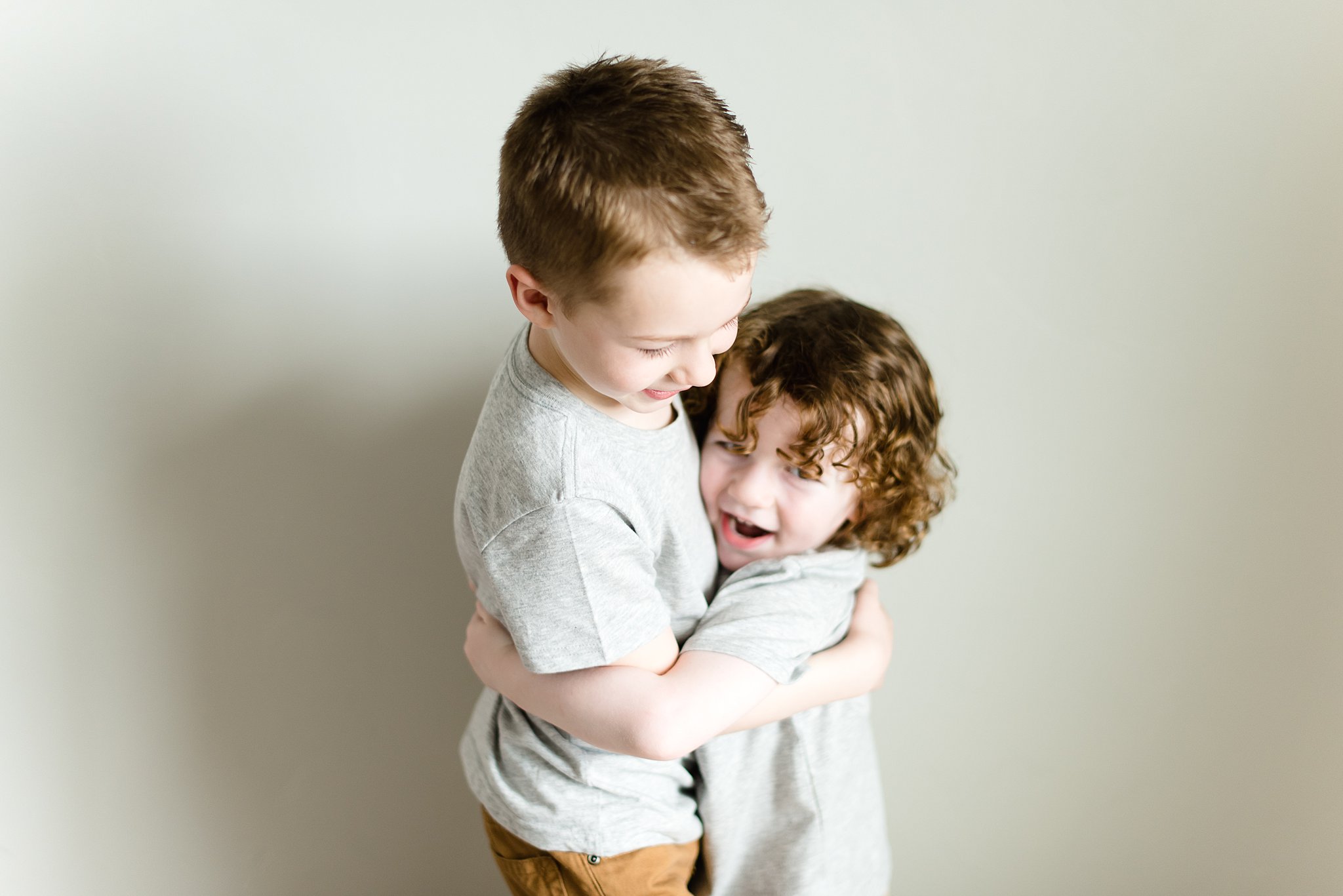  brothers hug in their bedroom  