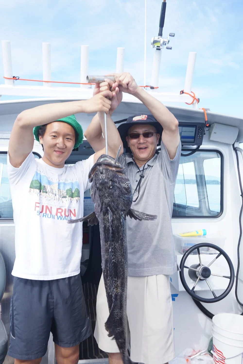 Lingcod Maxima - Dad John and son Justin out on a gorgeous day on Puget Sound. John gets his limit of one and then another Ling is on, Justin is reeling him in but sometimes the Ling was taking more line than Justin was pulling in. Finally at the bo…
