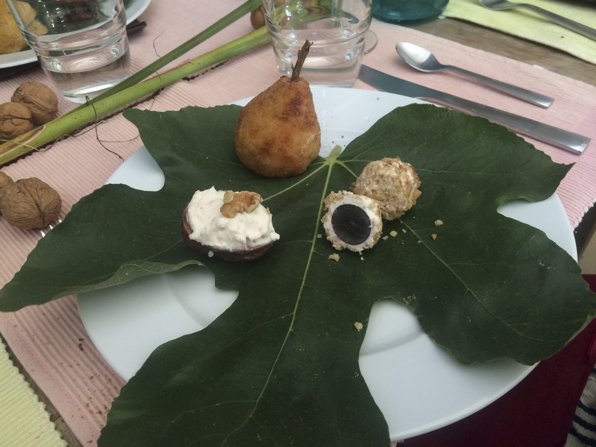 Creamy cheese in a half a walnut shell, grapes covered in cheese then rolled in nuts and a ball of crumbed risotto disguised as a pear.