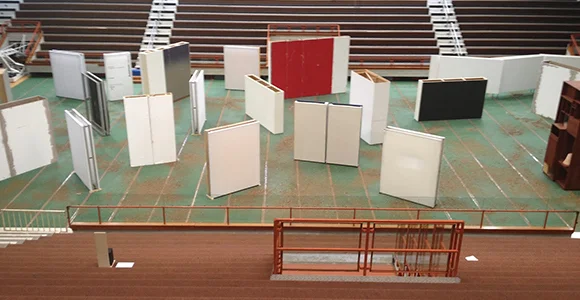 The Lithuania and Cyprus pavilion in the 55th Venice Biennale, oO, curated by Raimundas Malašauskas, proposes a living assemblage. It was held in a large public gymnasium located right next to the Arsenale, one of the main venues of the biennale. The sports activities do not stop when the show opens: the gym is running while the exhibition is running. It is a merge between the art exhibition and daily sport activities. In the exhibition, there is no single core or substance: art objects, non-art objects (balls, blooms, etc.), performance artists, local people, photographs, graffiti, lights, are equally distributed, while each element intersects with one another by being placed in a relation. Humans and non-humans, art and non-art, intersect with each other as they share the space together. What the viewer experiences are not just individual things, but the gestalt of an emergent whole. The multiple universes co-exist in one space.
JaeWook Lee (MFA AP14) writes on “Becoming a Volcano: The Lithuania and Cyprus Pavilion at the 55th Venice Biennale, o0 and Maria Hassbi’s Intermission” for INCIDENT Magazine.
