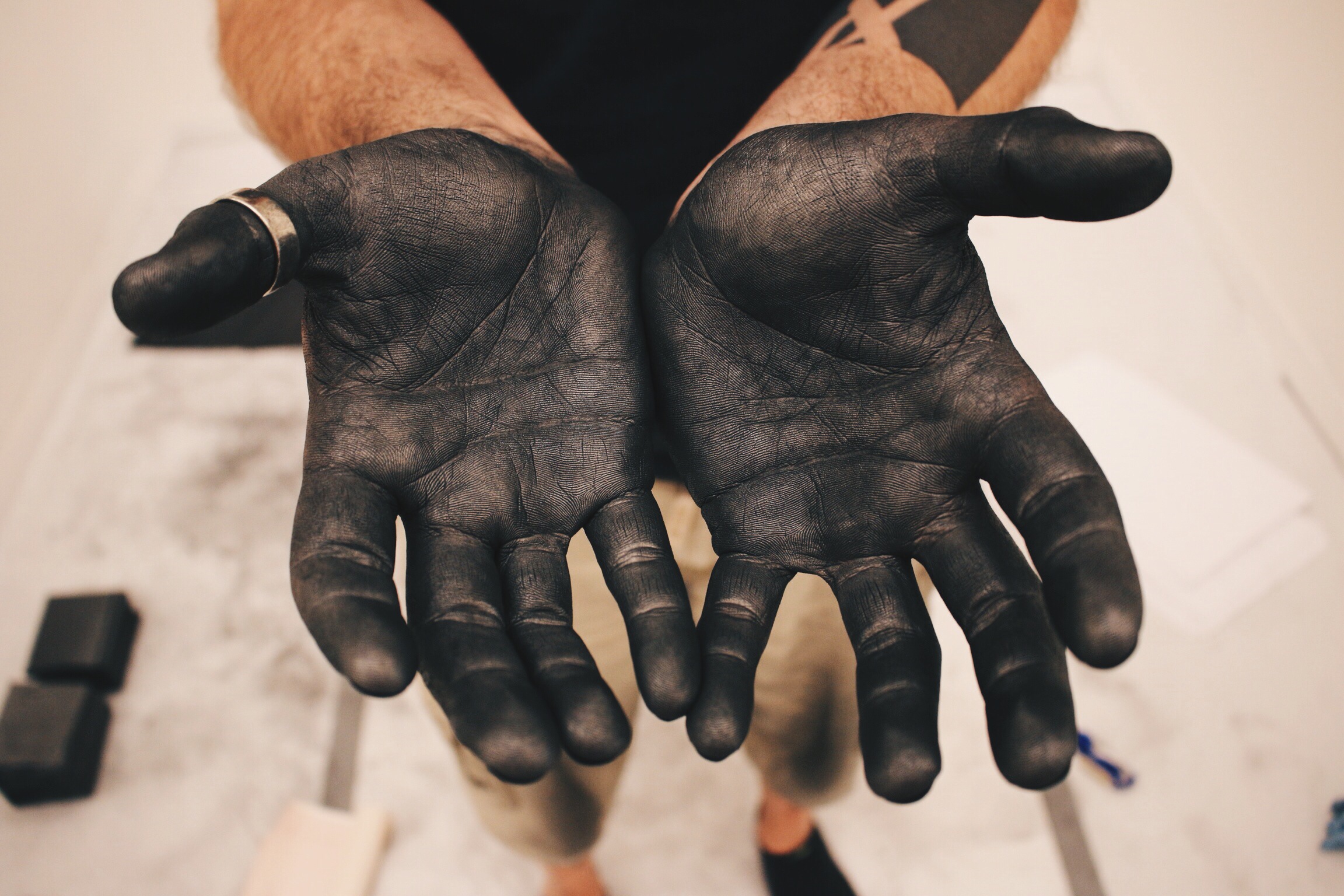  Hands covered by black graphite 