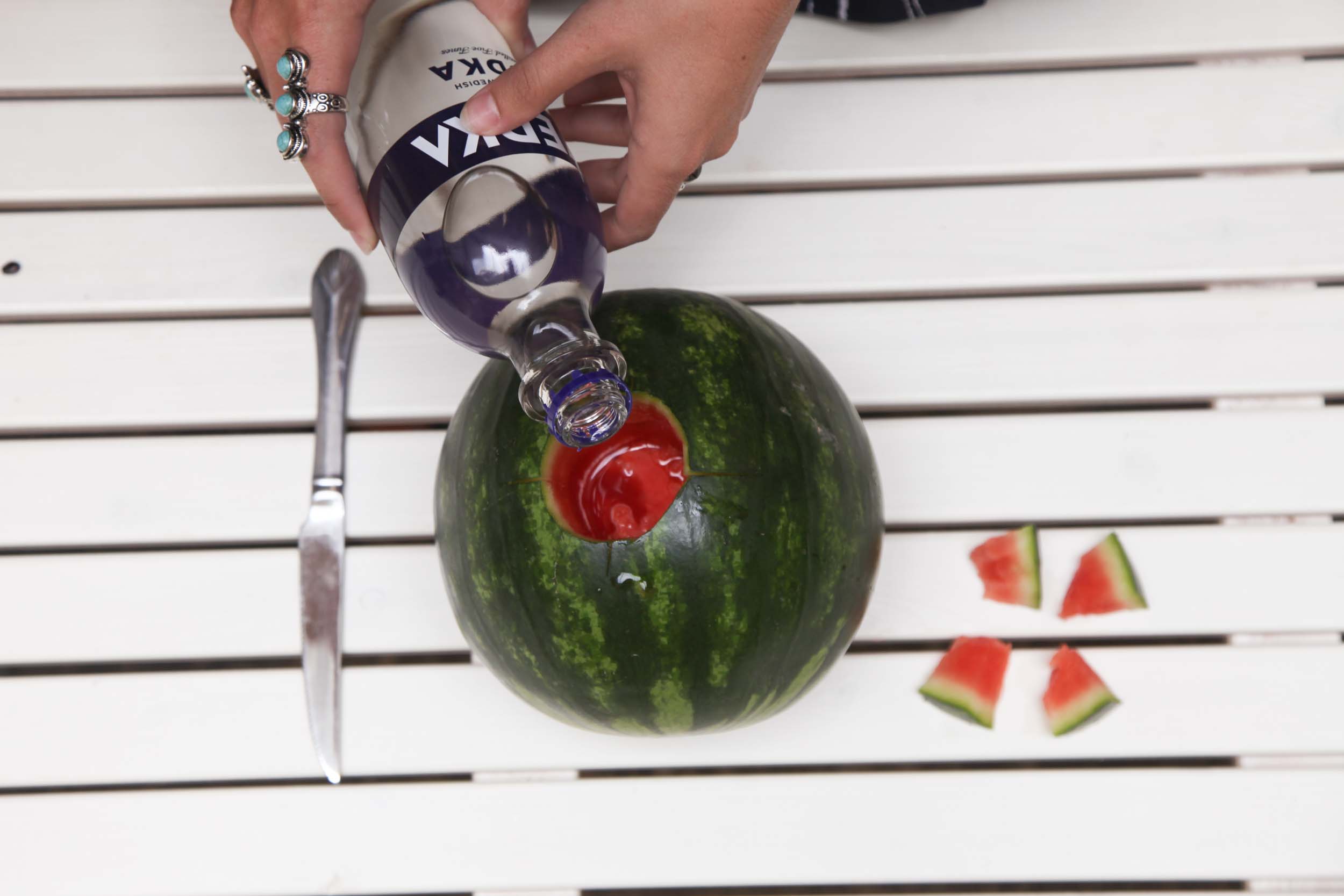 Pour half the bottle of vodka (roughly 12 oz/1.5 cups) directly into watermelon and let sit for 2 hours. (no cheating!)