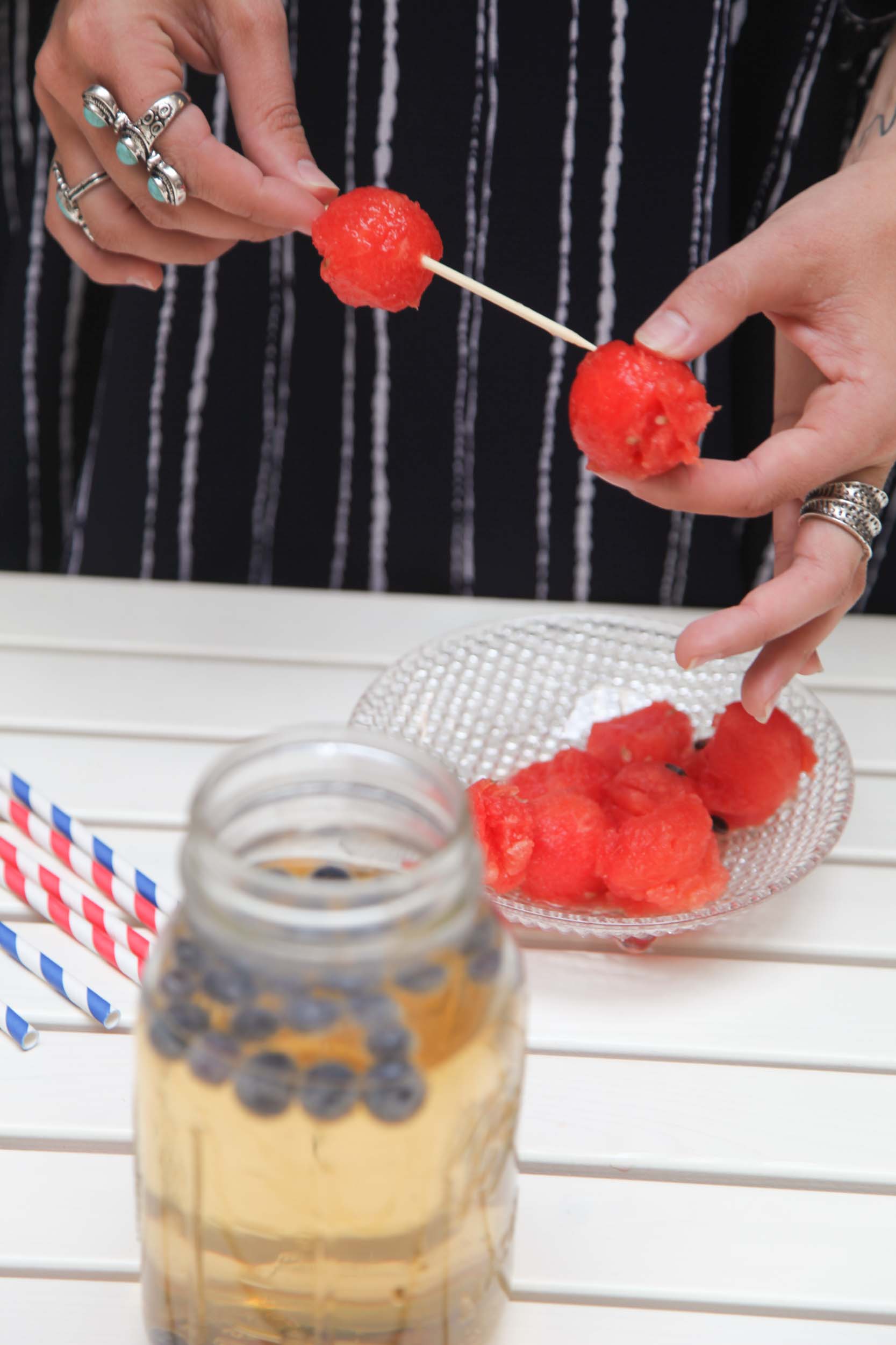 Finish it off with fruit. You can't go wrong with how much you add in. We chose to mix in a small handful of blueberries in each glass but if you want a sweeter drink, add more! Add you final touch, vodka melon skewers and enjoy.