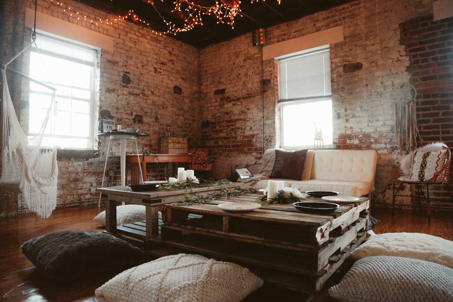 I live in a tiny, one-bedroom, old mattress factory loft. It is perfect size for me and well..my dog, but trying to fit all of my friends gets tricky. So I decided to keep my guest list small, invite my 10 closest friends, and then make the rest work. I rearranged my WHOLE house. I hid things that were unnecessary for the night such as my TV and small furniture that took up space in my closet or laundry room - and then I got crafty! Knowing that my tiny table-for-two would be no good for the night, I created a long rectangular table by stacking three pallets on top of each other and used other little tables I had around to display all the food. We then sat around the quaint little pallet table with floor pillows and enjoyed our fun & non-traditional Friendsgiving in the most bohemian way possible.