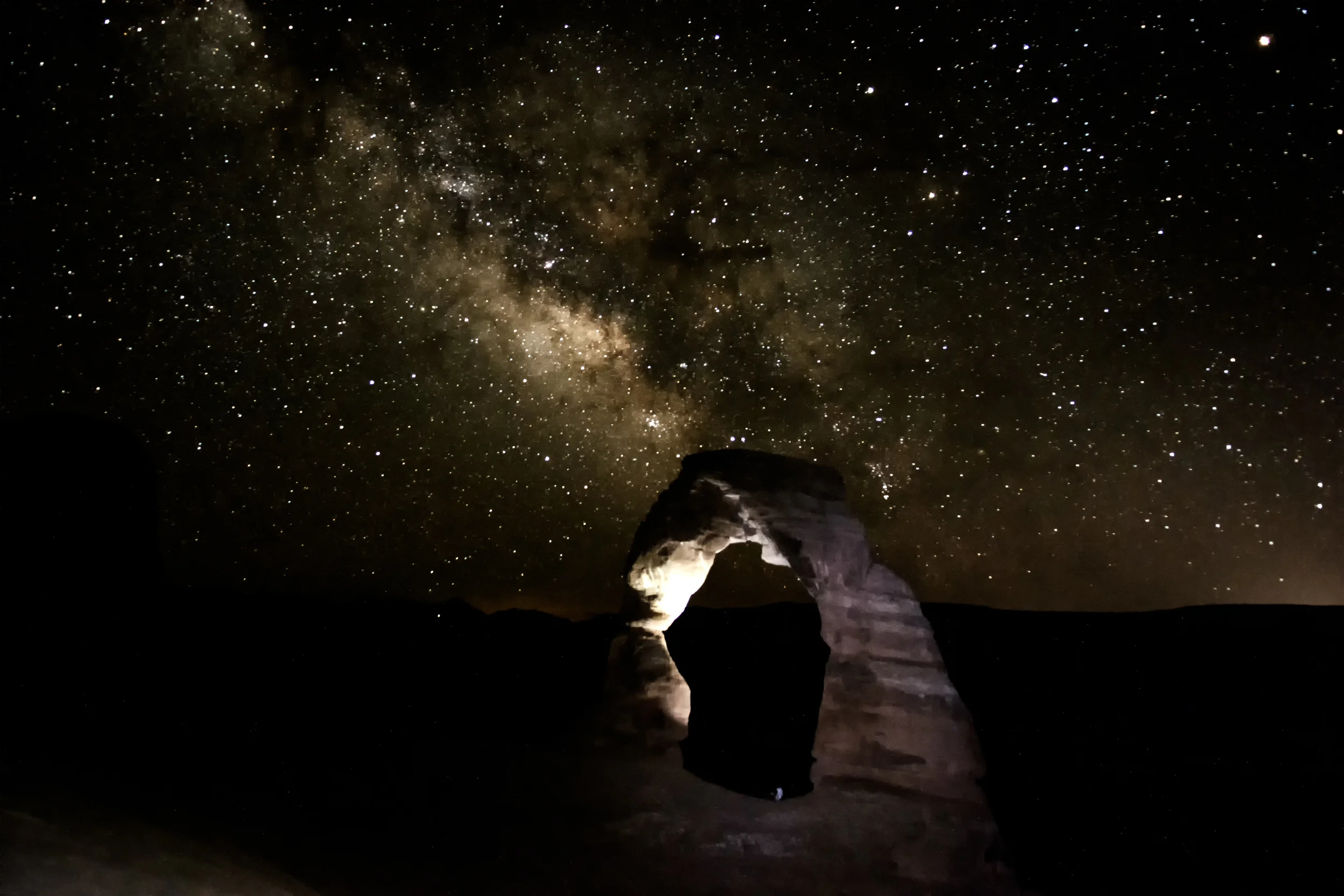 6/26 Photo: Delicate Arch with the Milky Way behind it. That tiny white dot in the middle is a person, just to give some perspective! It was truly incredible to sit on top of a mountain in the desert so late at night and hike out by headlamp. 