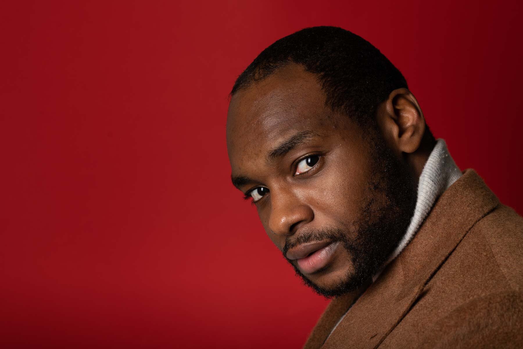  My client was happy to pose in front of this deep red background in the studio 