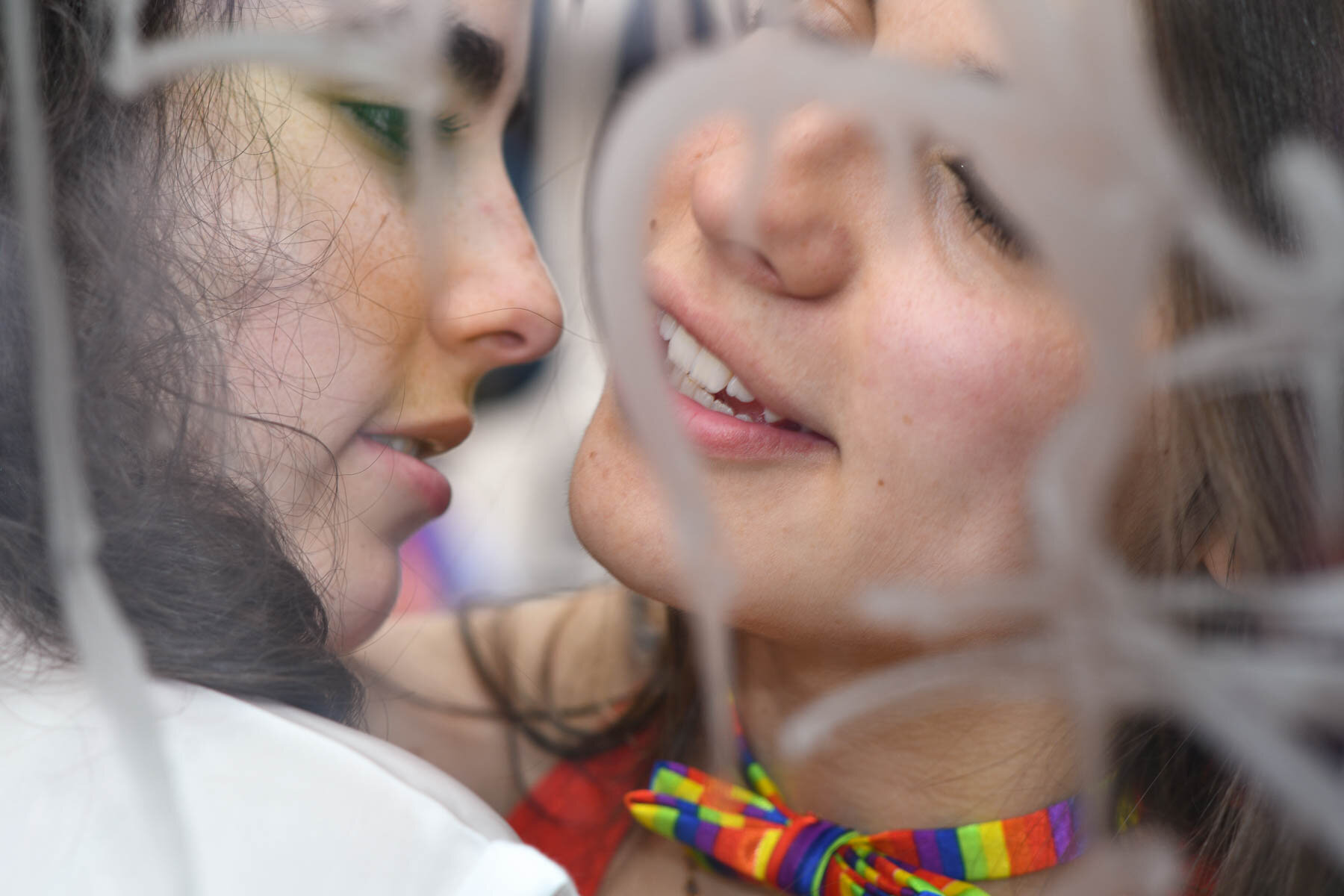  Young women kissing in a bus shelter. 