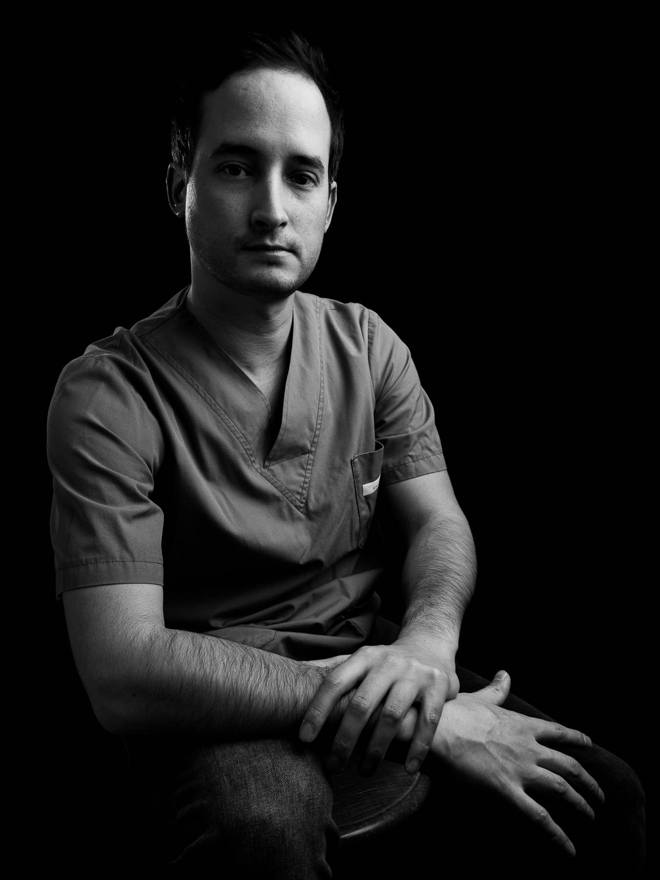  Studio portrait of a young plastic surgeon, emphasising his hands 