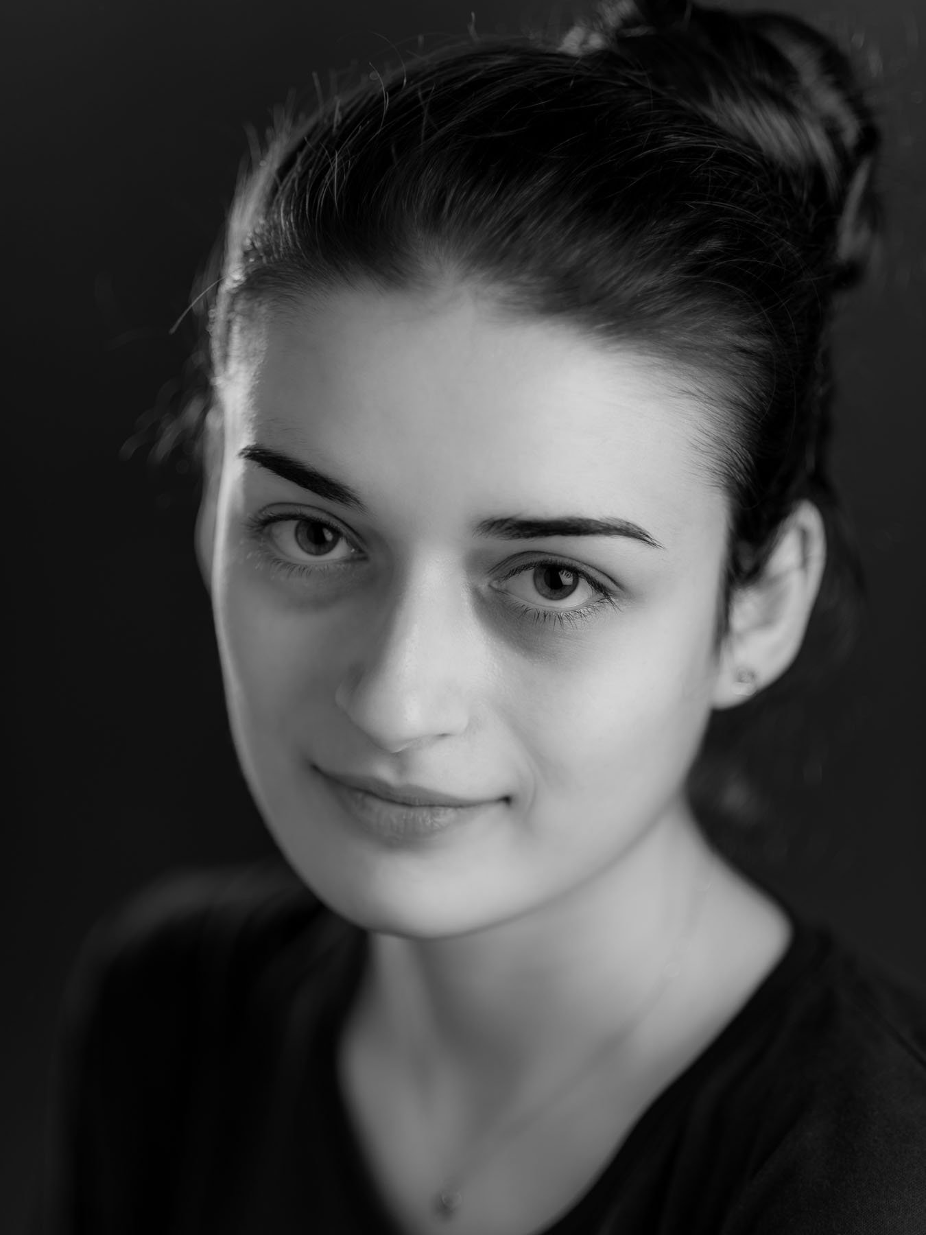  1940s-style black and white studio portrait of a young woman 