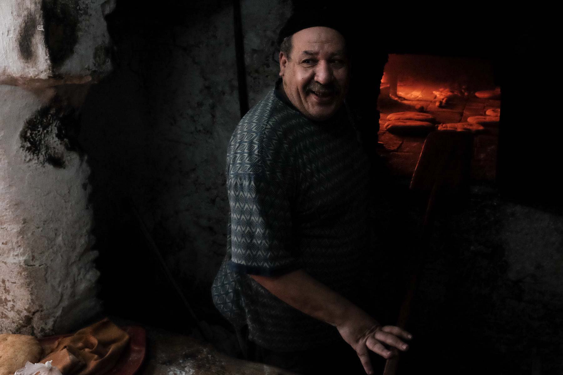  Neighbourhood baker, Fez. Women bring the family’s bread to be baked. He marks each one with a different pattern in order not to mix them up. He told me that he had been working in the same oven pit for 40 years. 