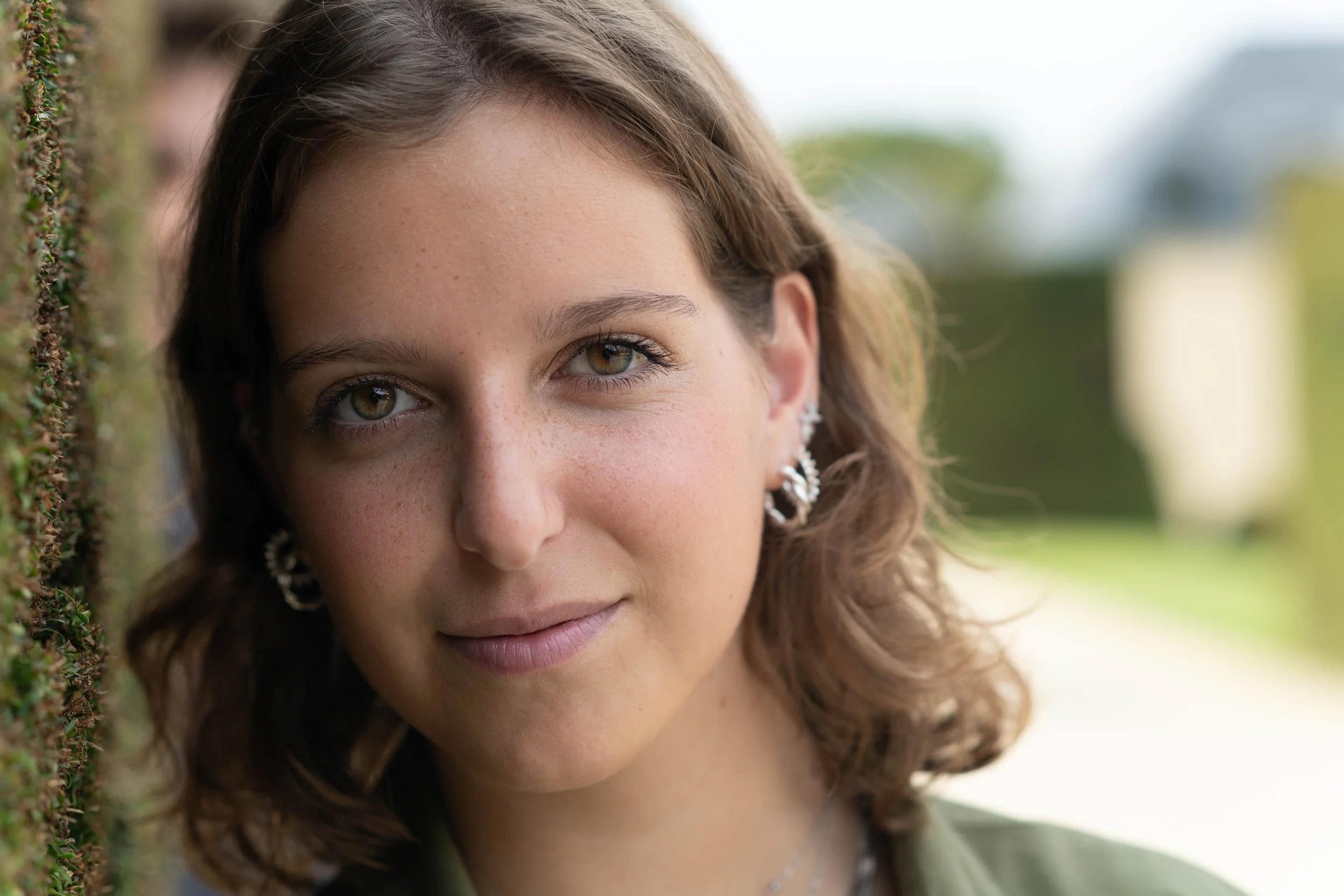 Close-up portrait of a young woman in a park