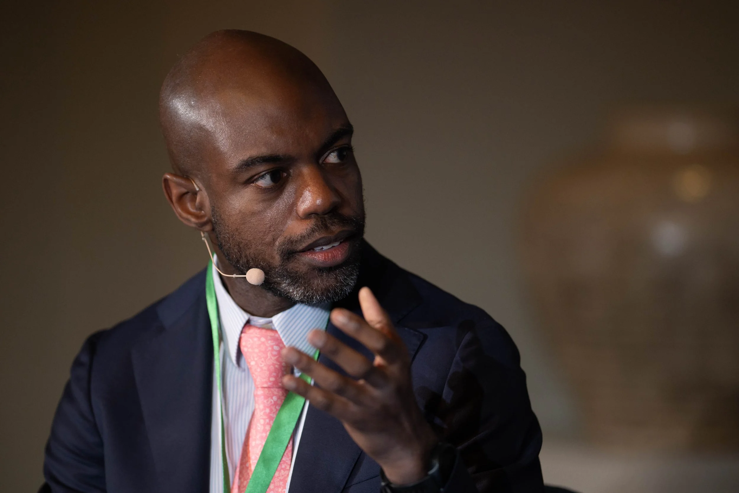 A conference speaker in discussion with panellists