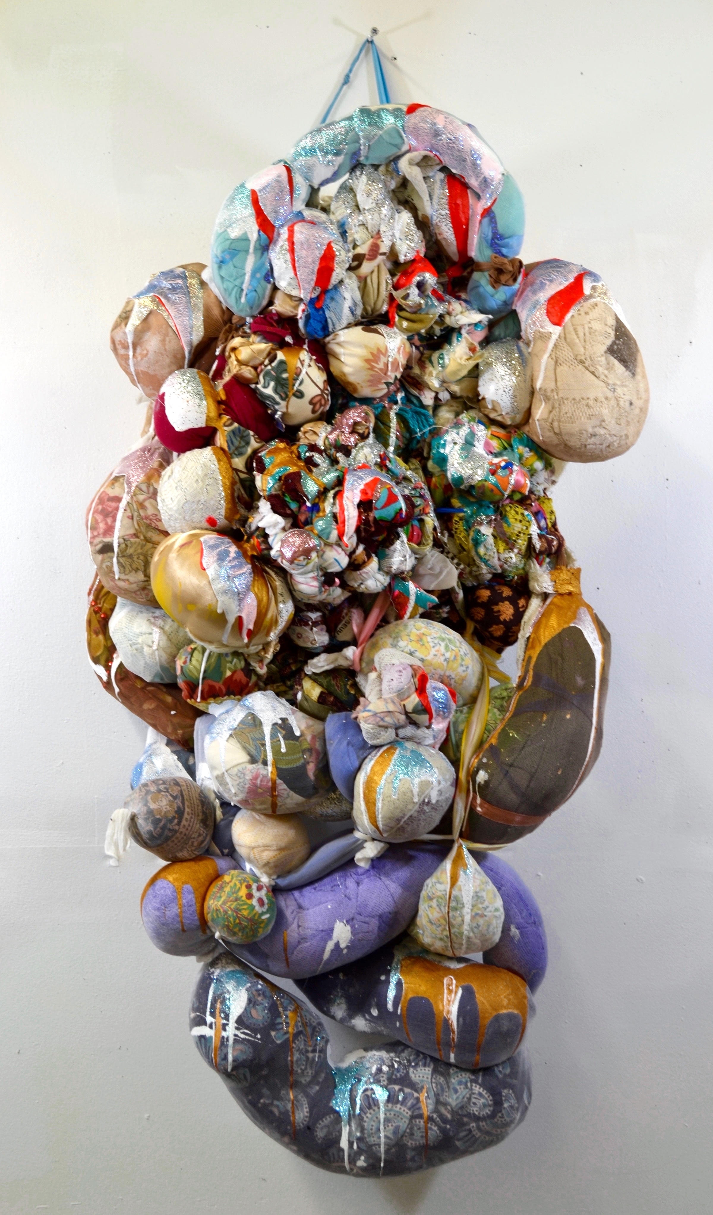 2015, Hang In There Hanging sculpture made of knotted and shredded canvas, upholstery, curtains, lace, stuffed pantyhose, ribbon, beads, glitter and acrylic paint.