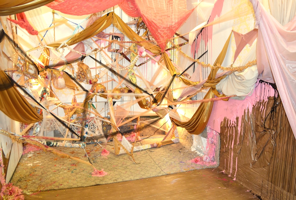  2015,  Spun Out   Studio installation 10'X10'x10'. Tulle, synthetic silk, lace, faux-wood adhesive contact paper, rug, fake flowers, glitter, house paint, acrylic paint, stretcher bars, curtains, spray foam insulation. 