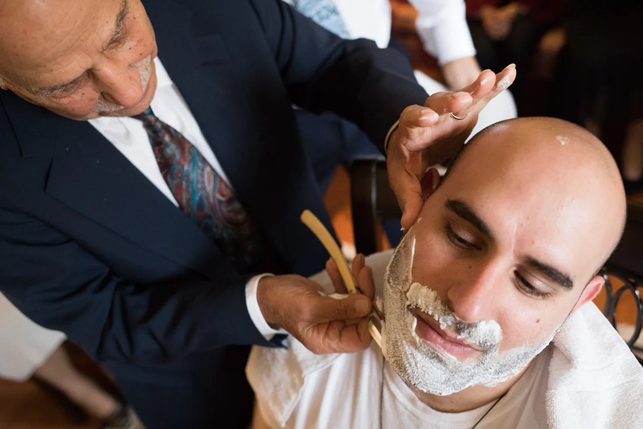 Groom's grandfather shaving him