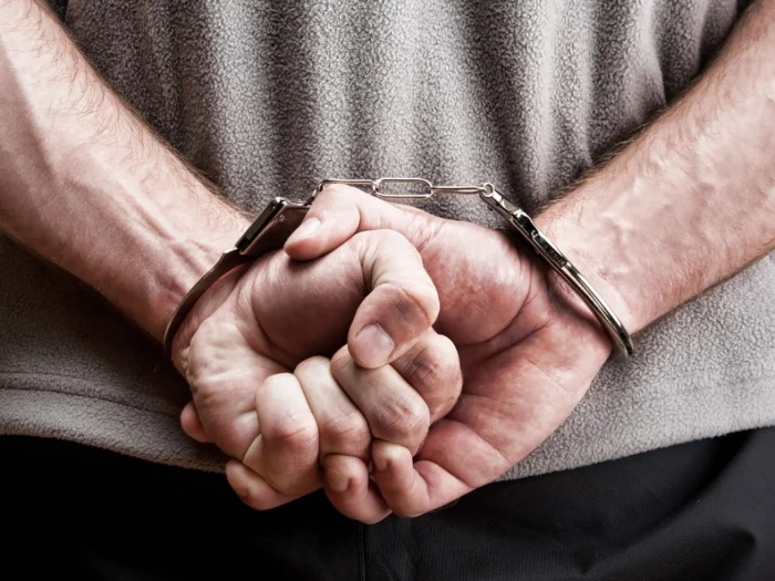 bigstock-Criminal-In-Handcuffs-14611325.jpg