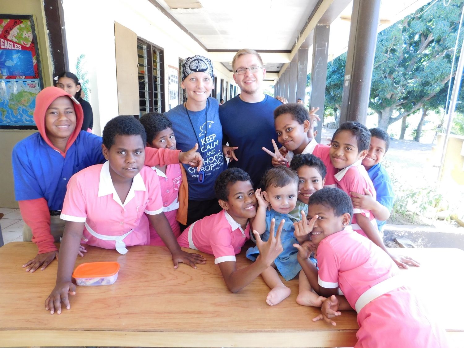 Drs. Hannah and Alex with students on outreach trip