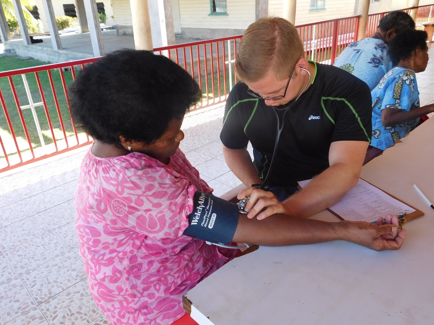 Dr. Alex Wolfe performing BP and CV exam