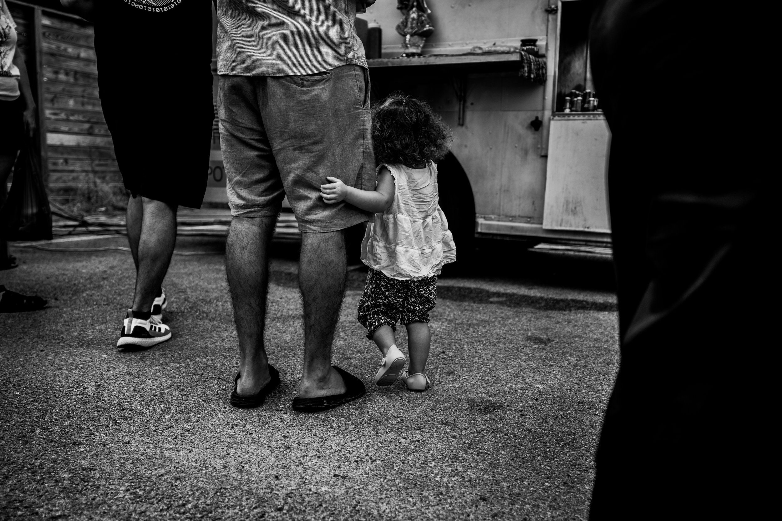 Little girl hugging her daddy's leg