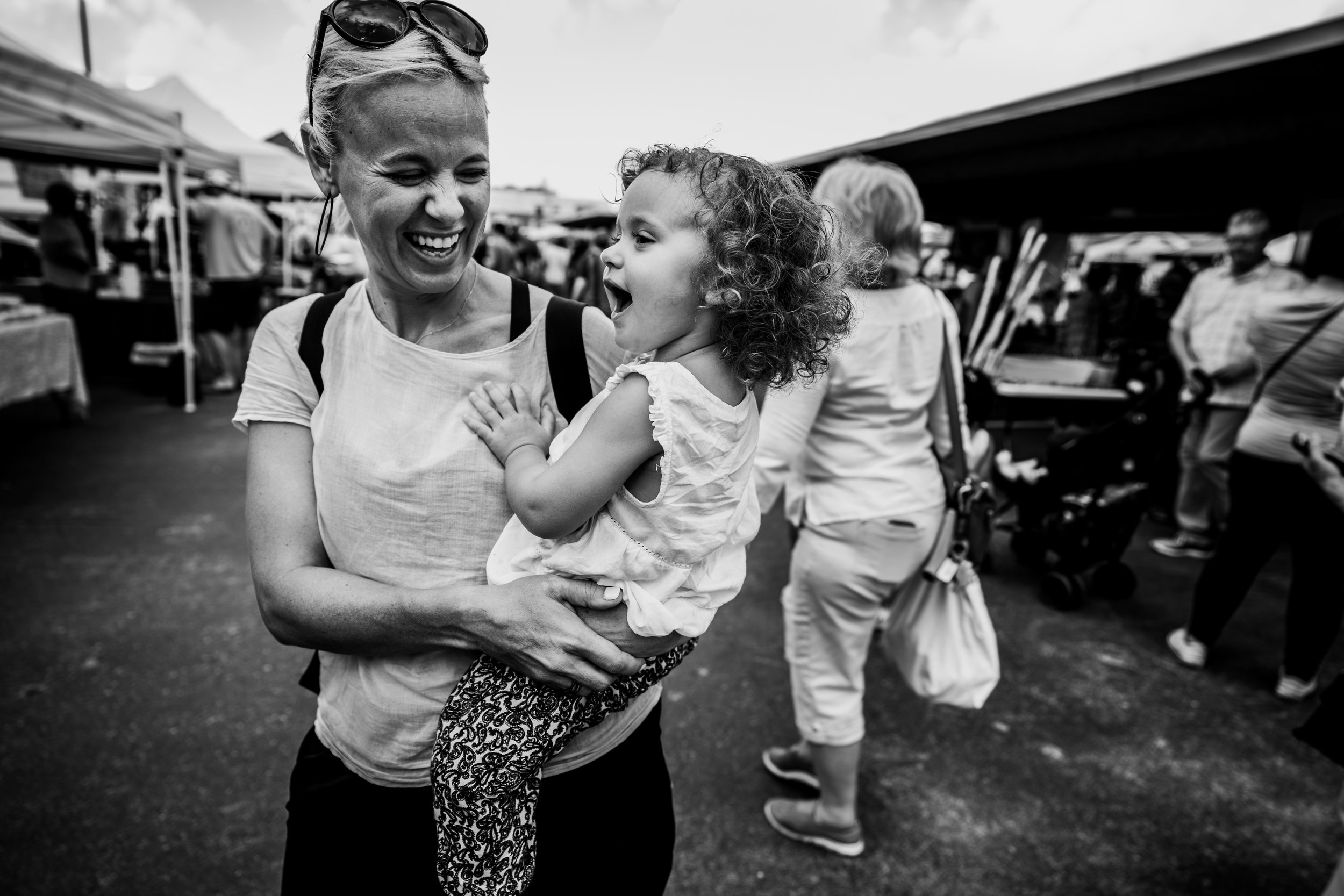Little girl sings while her mom holds her