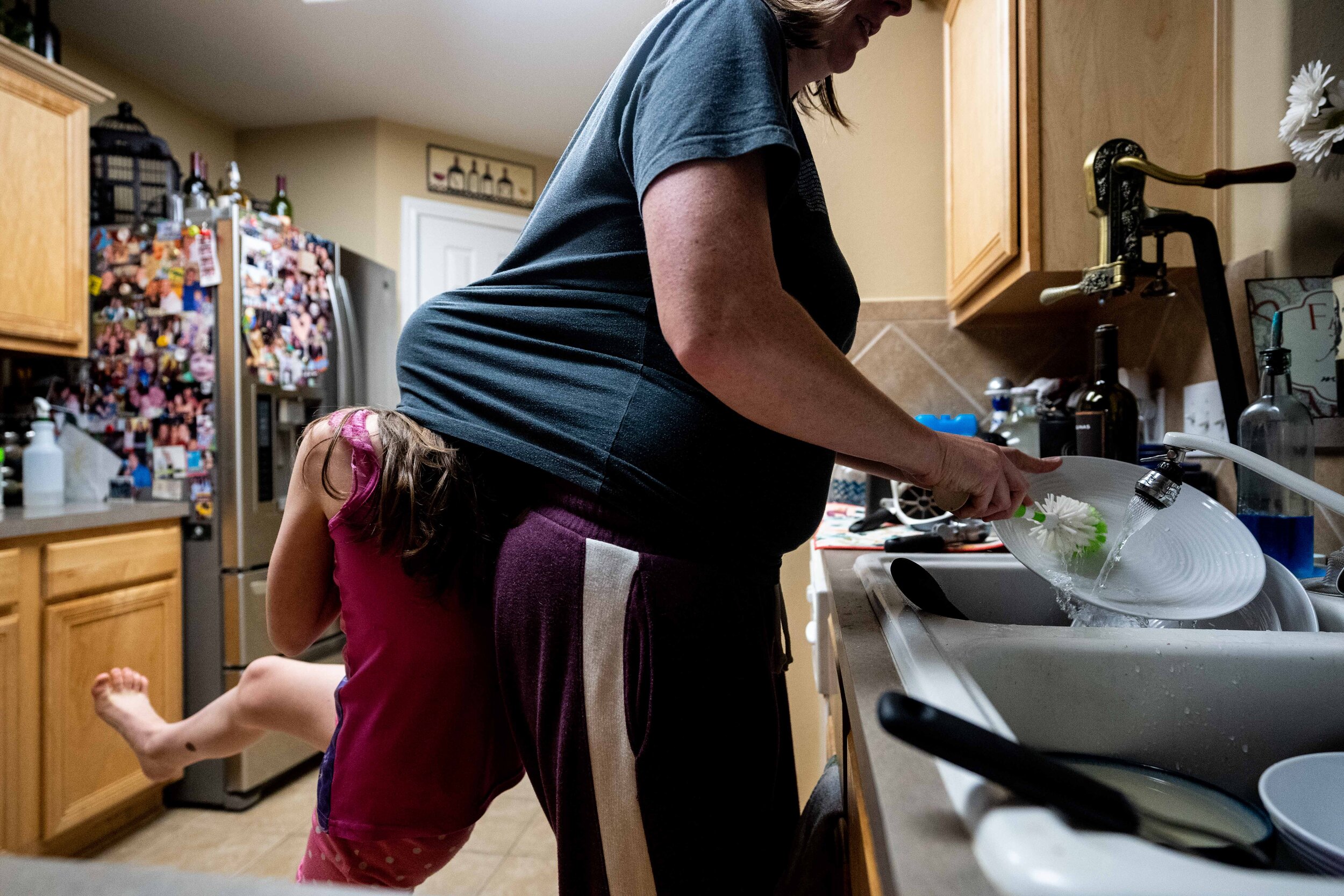 documentary family photographer in houston - mom doing dishes-1.jpg