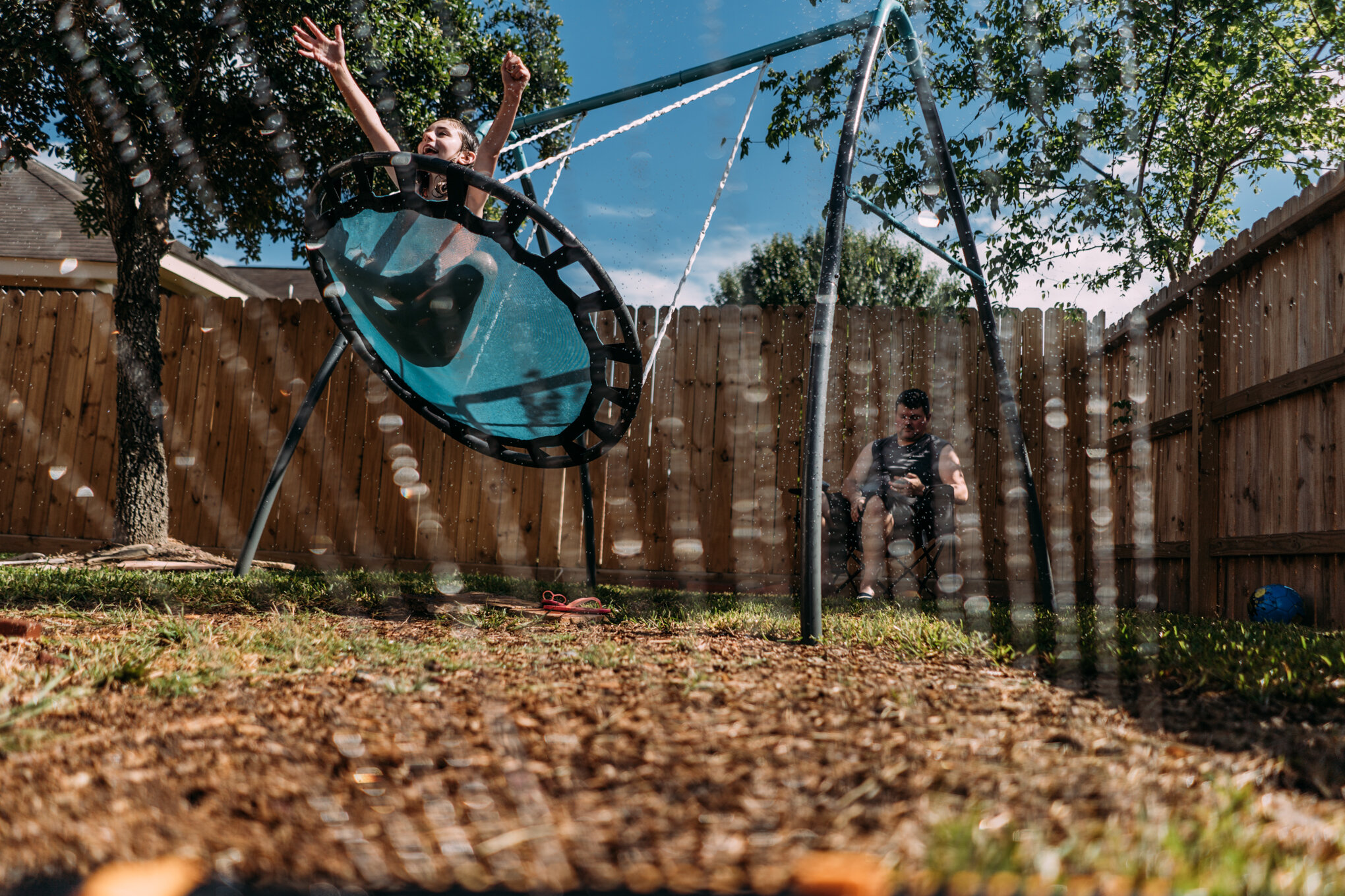 sprinkler spraying child on a swing-1.jpg