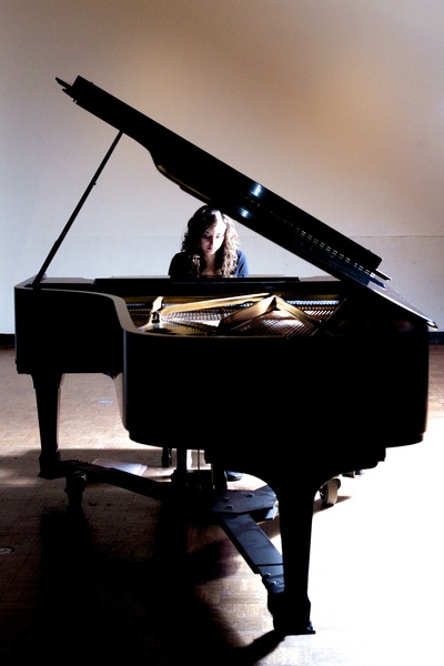 Angelica Delia plays a piano in Robert Glidden Hall at Ohio University.