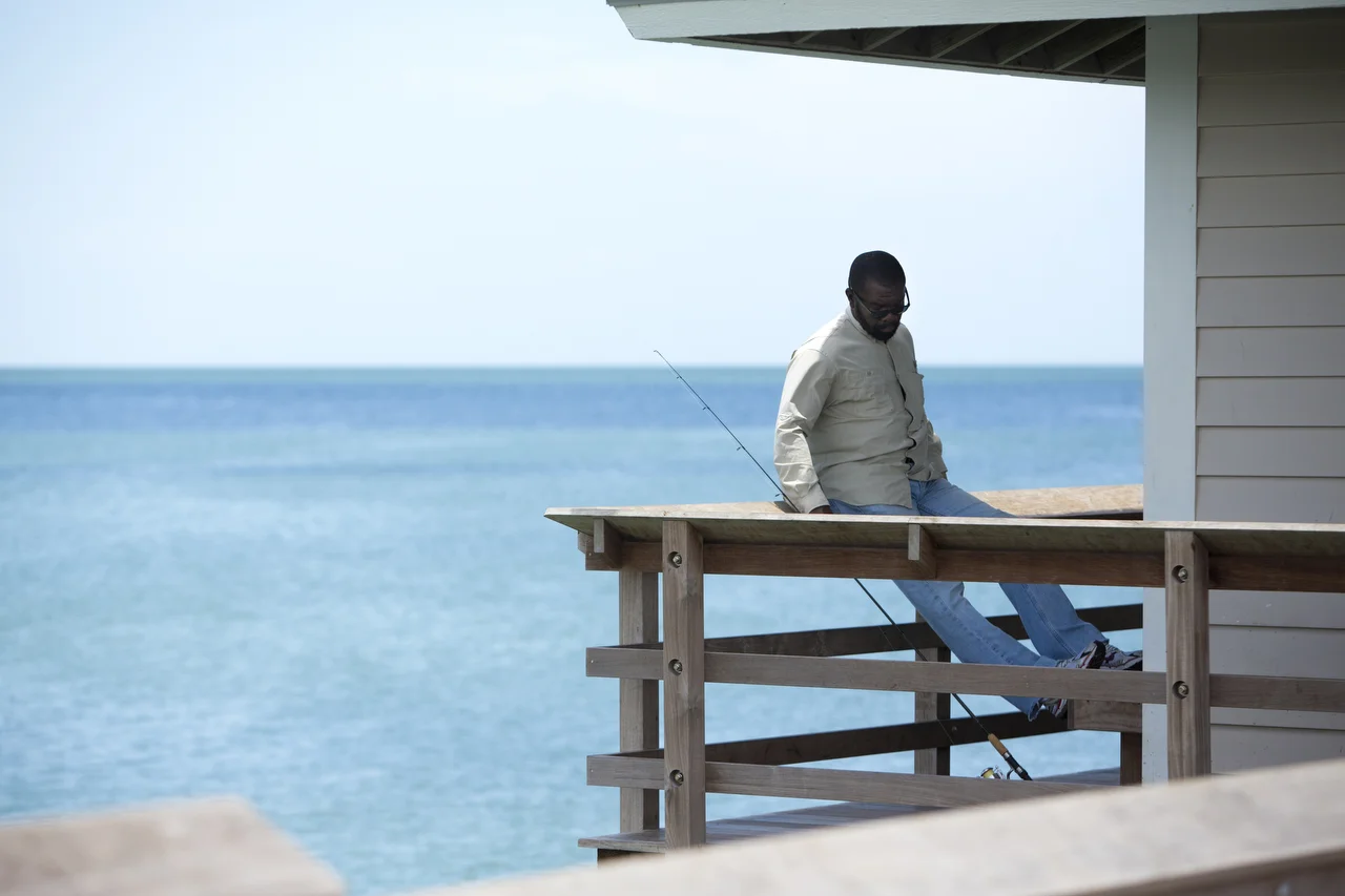  Sly Robinson takes a break from fishing on the Naples Pier on June 20, 2016. 