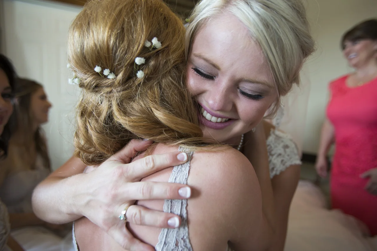  My stepsister Samantha Masters on her wedding day hugging best friend, Carolyn Beatty. 