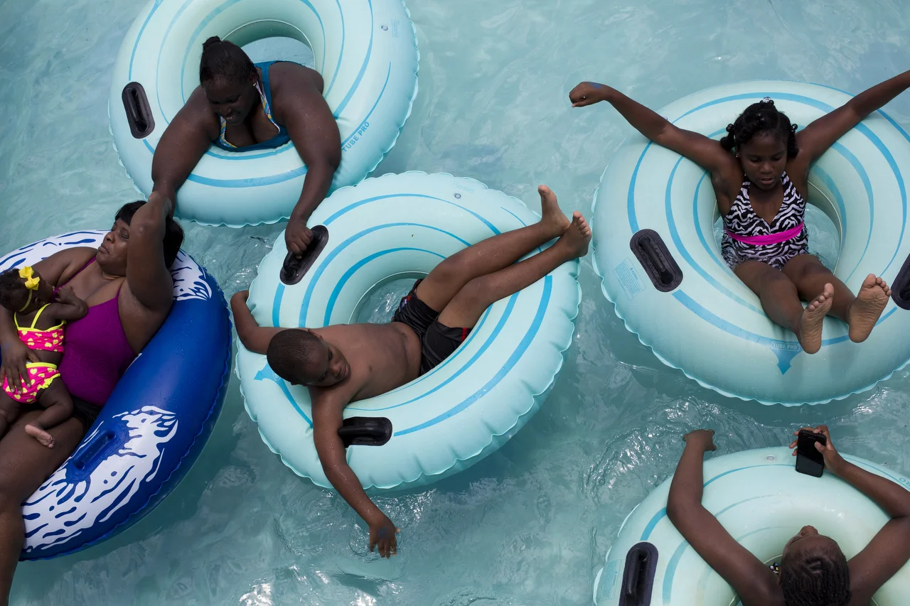  A family floats by on the lazy river at Sun-N-Fun Lagoon in Naples on July 8, 2016. 