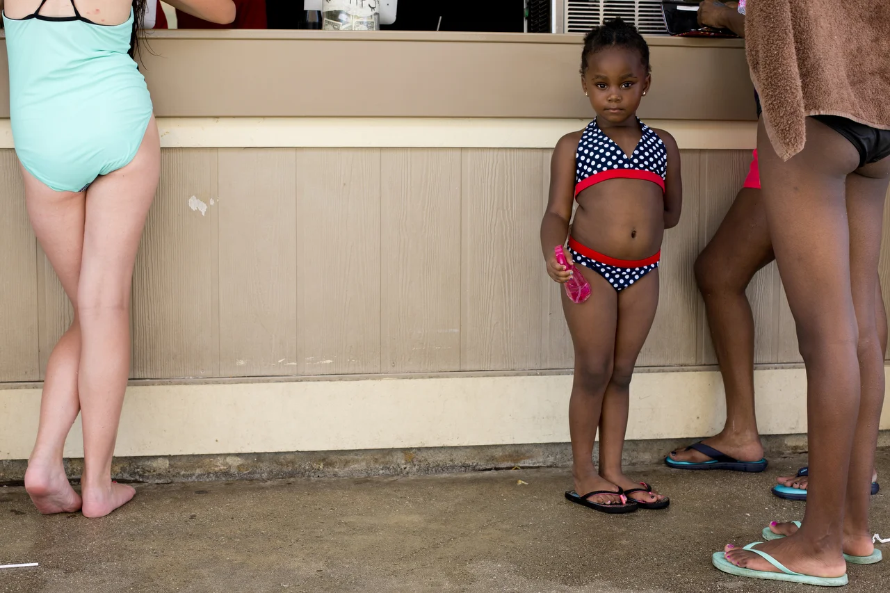  4-year-old Jesenia Maldonado waits as her family orders food at Sun-N-Fun Lagoon in Naples on July 8, 2016. 
