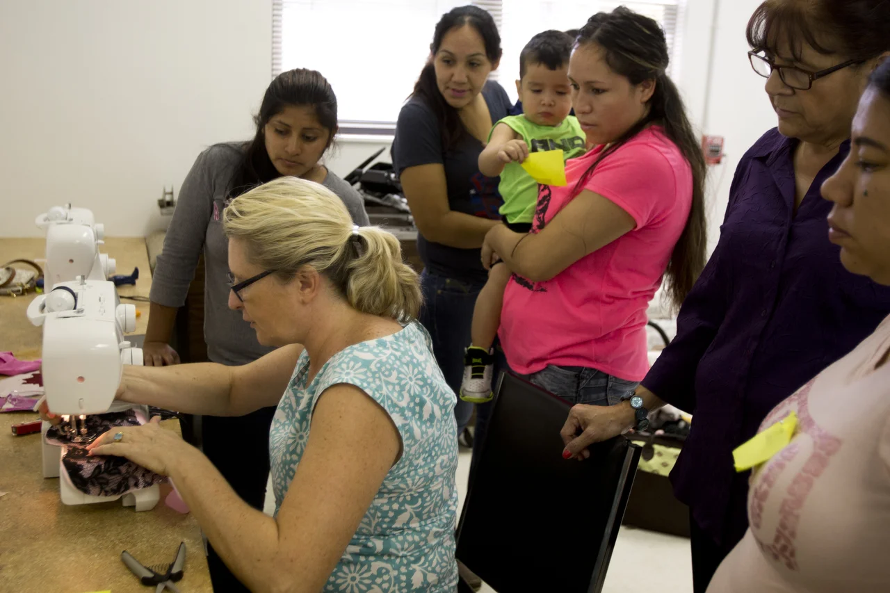  Fashion designer Gwendolyn Gleason demonstrates sewing skills for a group of women in Immokalee on July 6, 2016. Handmade Immokalee is a weekly class devoted to helping local women develop sewing skills. 