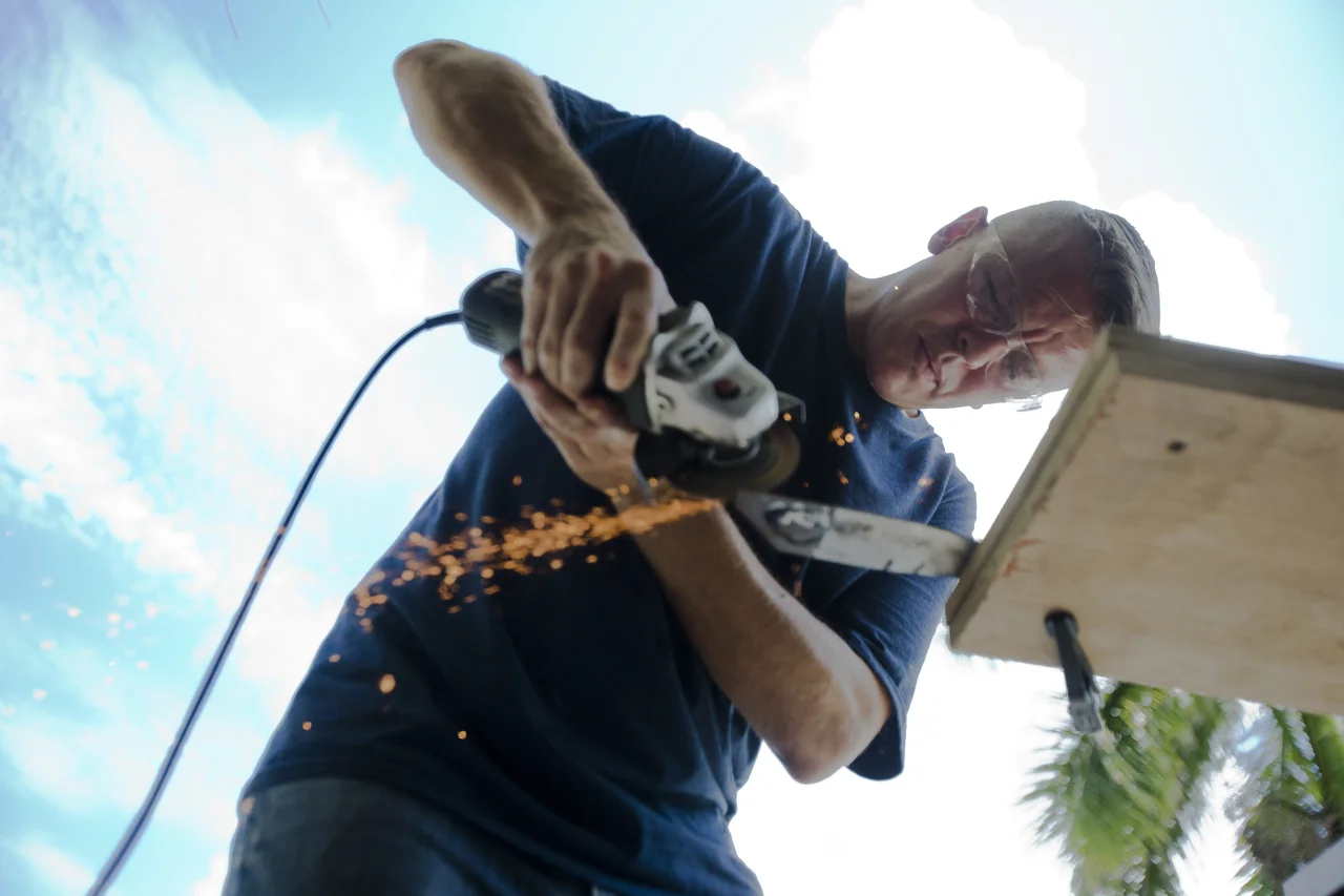  James Grosser, a bladesmith for his own cutlery business, works on a handmade knife out of his shop in Naples on July 14, 2016. 